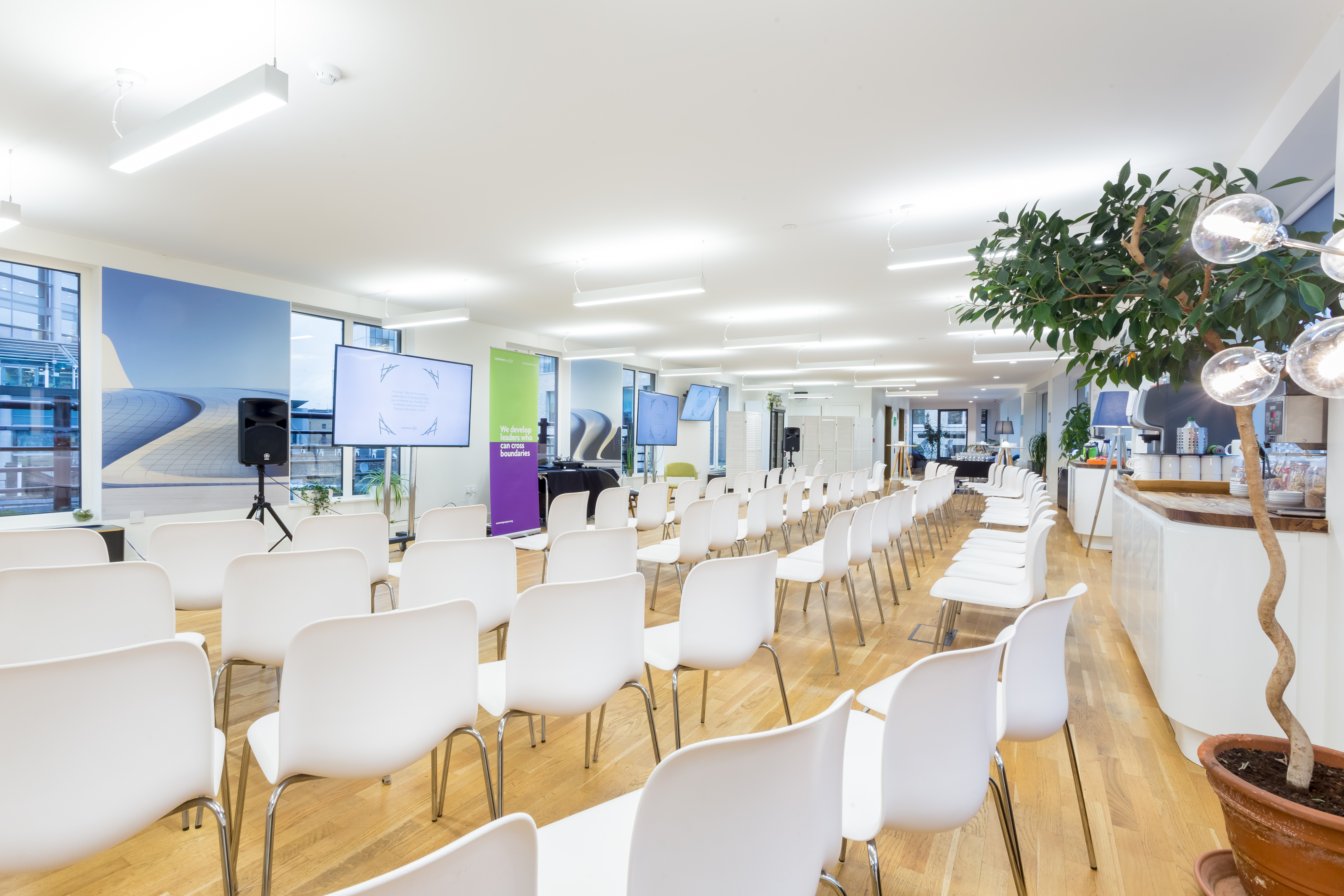 Rooftop Kitchen event space with white chairs, ideal for corporate meetings and workshops.