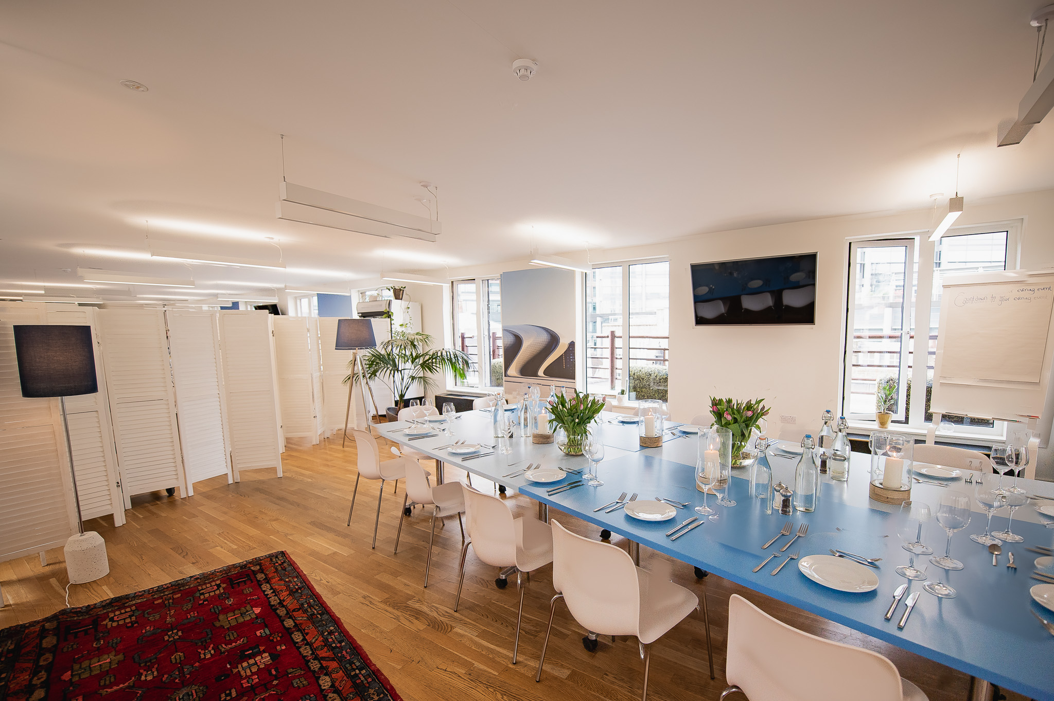 Rooftop Kitchen meeting space with blue table, ideal for events and gatherings.