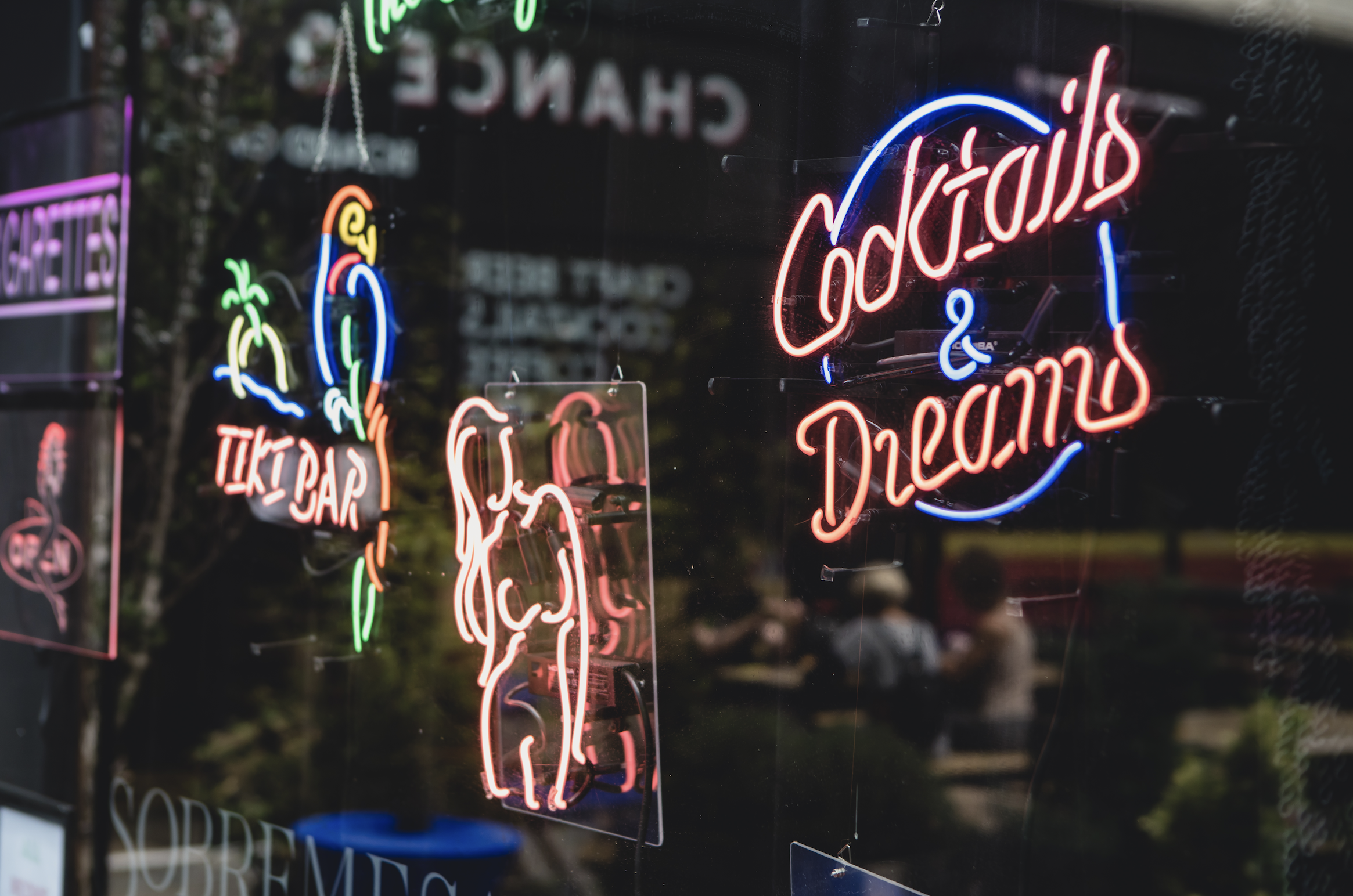 Vibrant neon signs at Sobremesa Bar, perfect for cocktails and social events.
