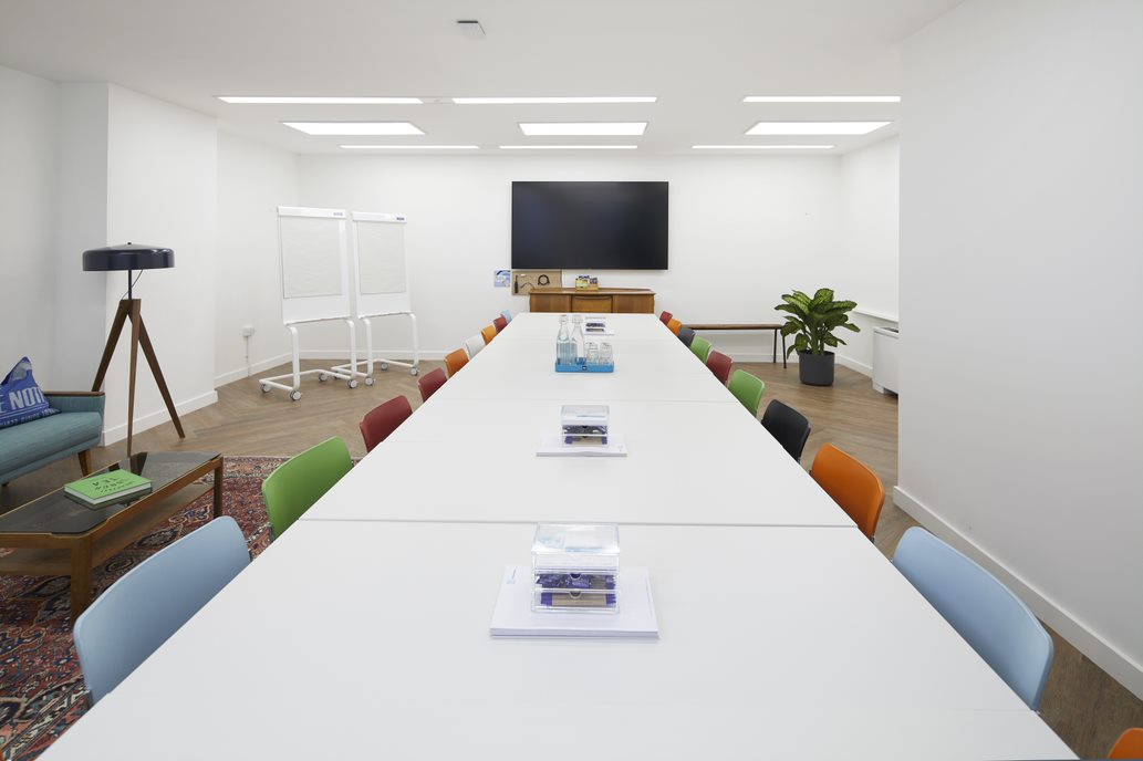 Modern meeting room in Wallacespace Covent Garden with vibrant chairs for creative collaboration.