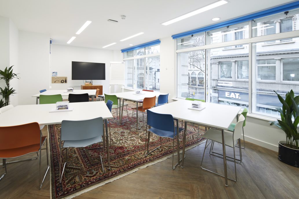 Modern meeting space in Covent Garden with colorful chairs for workshops and brainstorming.