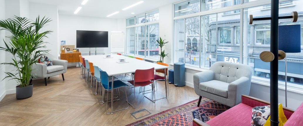 Modern meeting space in Covent Garden with colorful chairs, ideal for workshops.