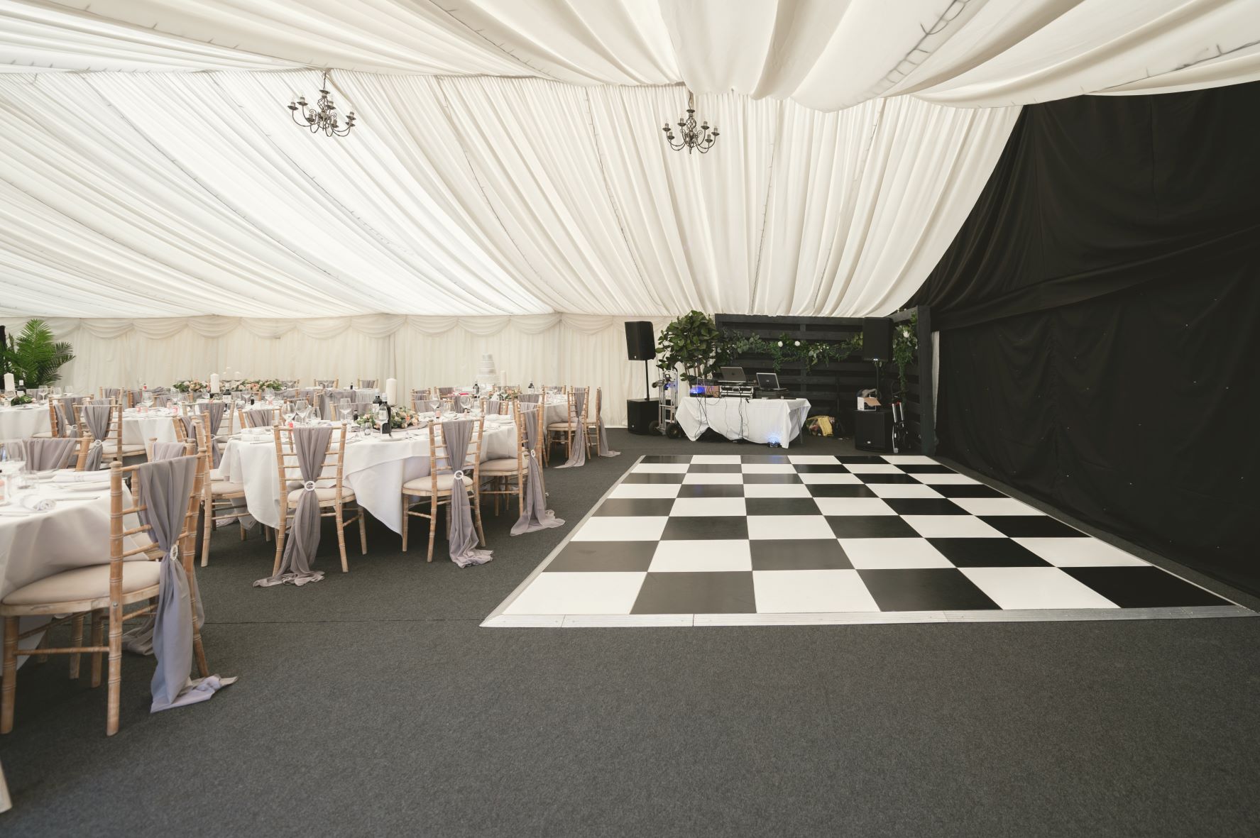 Elegant event space at Cave Hotels with round tables, perfect for weddings and gatherings.