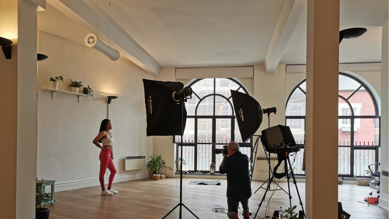 Bright yoga studio with large windows, perfect for creative events and photo shoots.