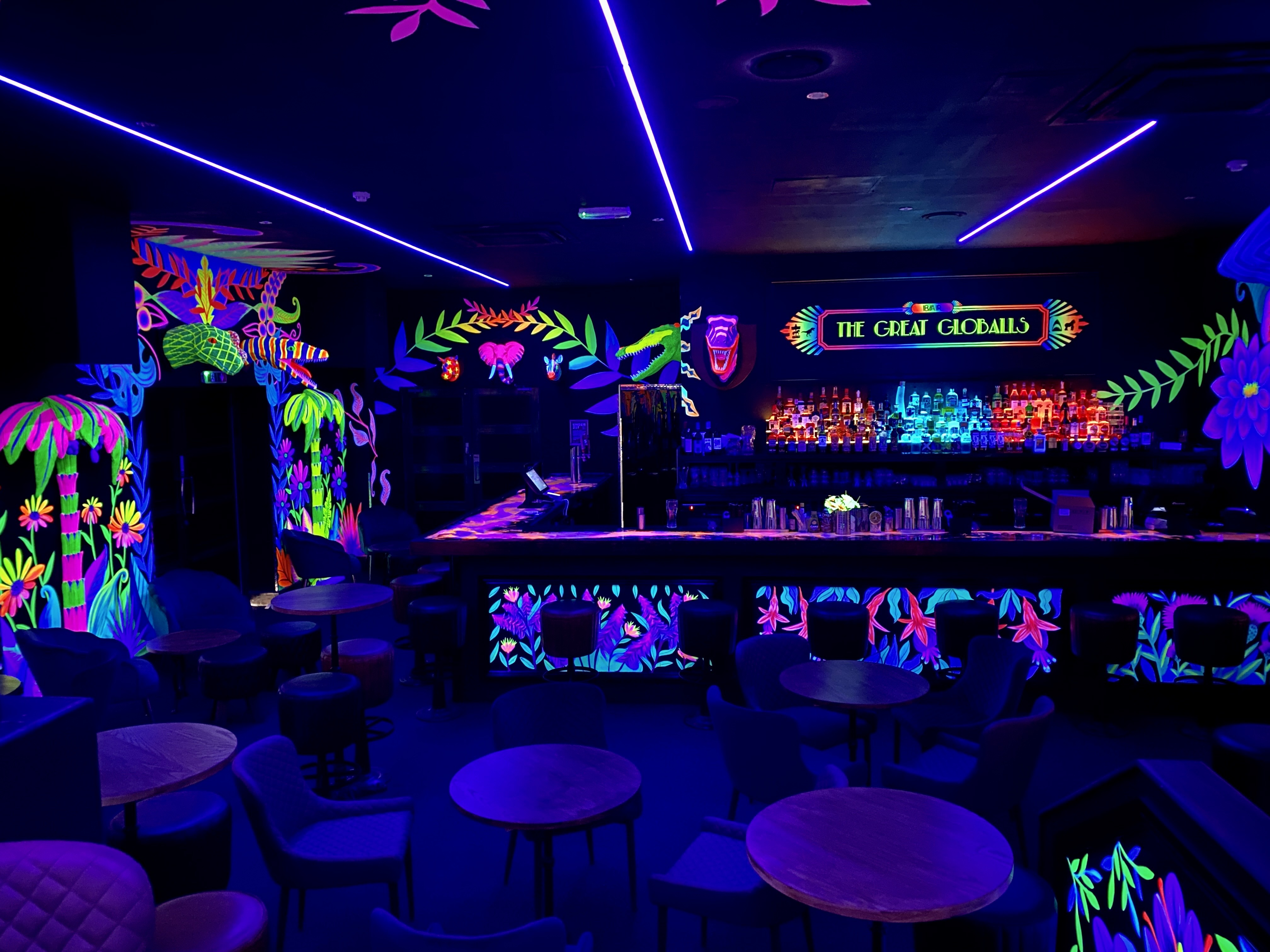 Vibrant neon-lit bar space for themed parties and social gatherings.