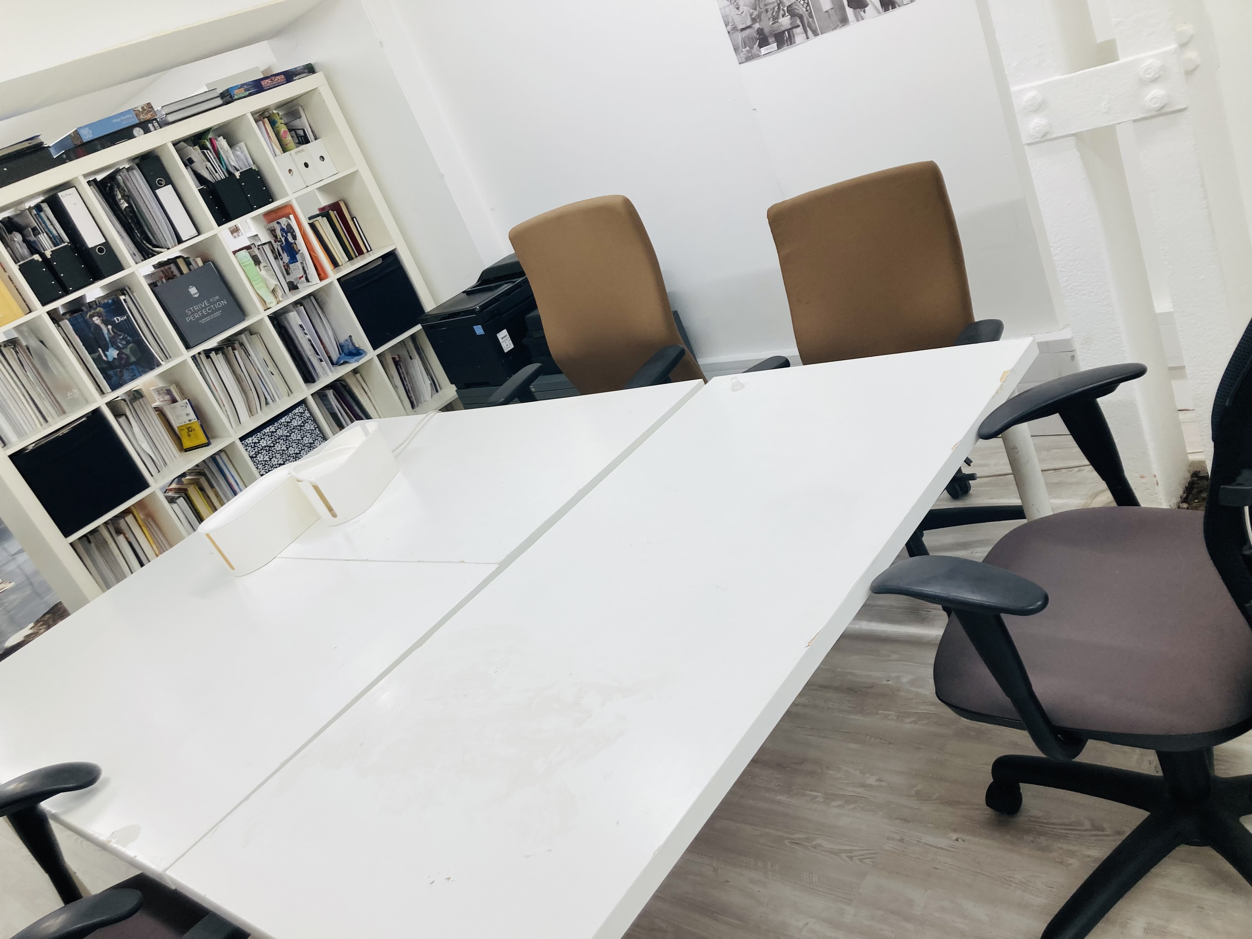 Modern meeting space with sleek white conference table for team brainstorming sessions.