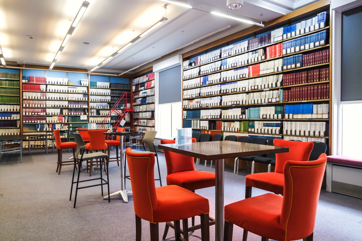 Wheatley Room meeting space with vibrant orange chairs, ideal for workshops and brainstorming.