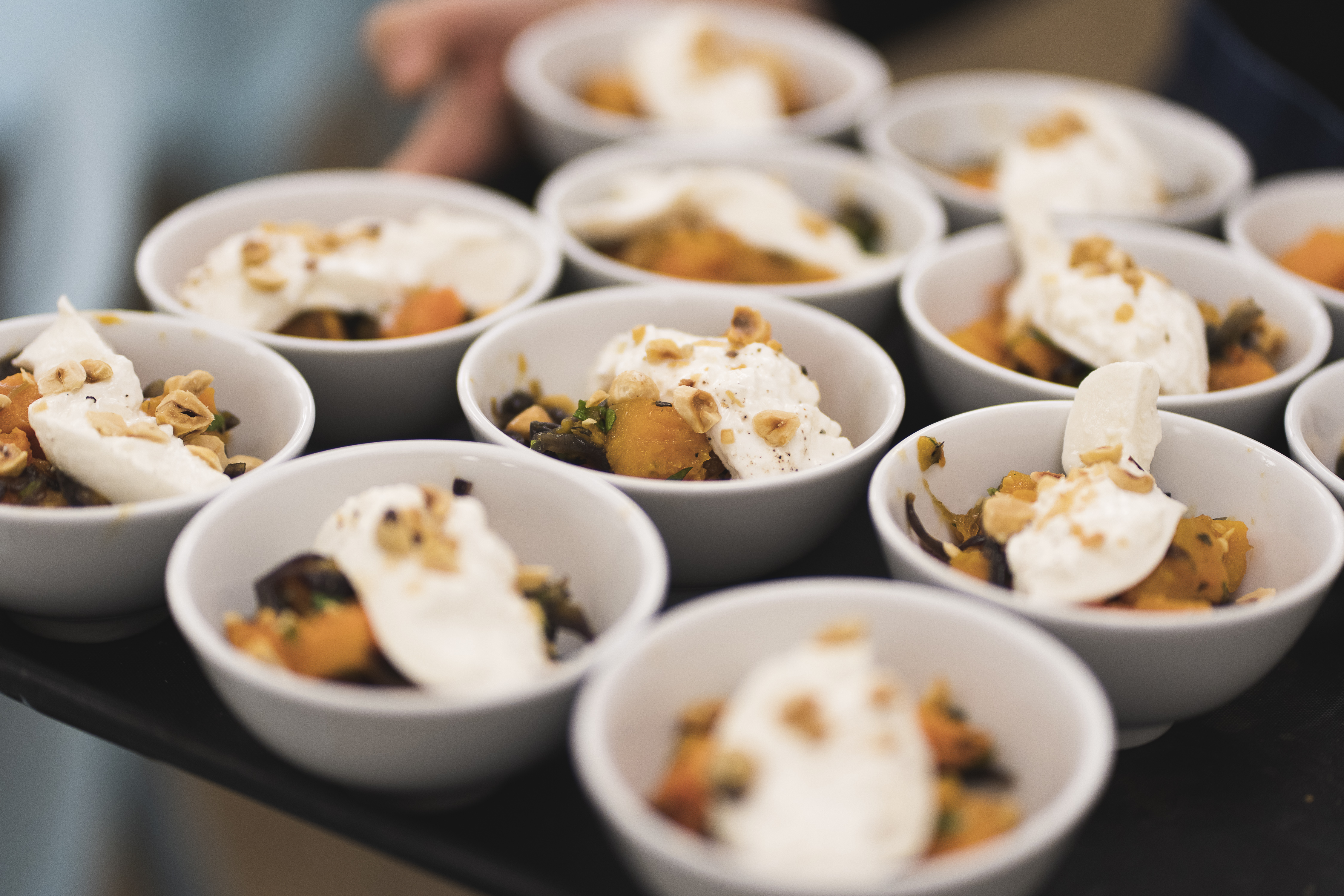 Elegant dessert cups with whipped cream for upscale events and catering.