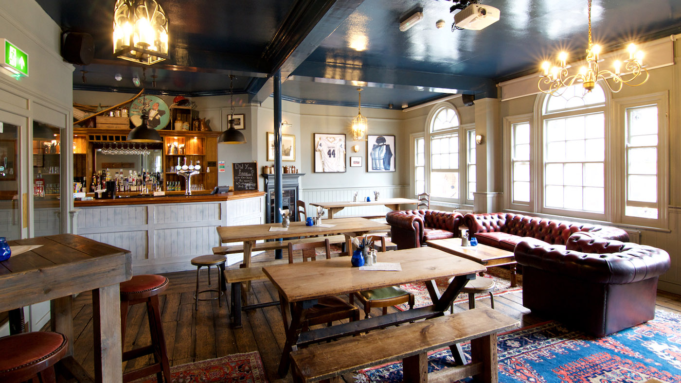 The Blue Room at St Aldates Tavern, featuring rustic tables for events and gatherings.