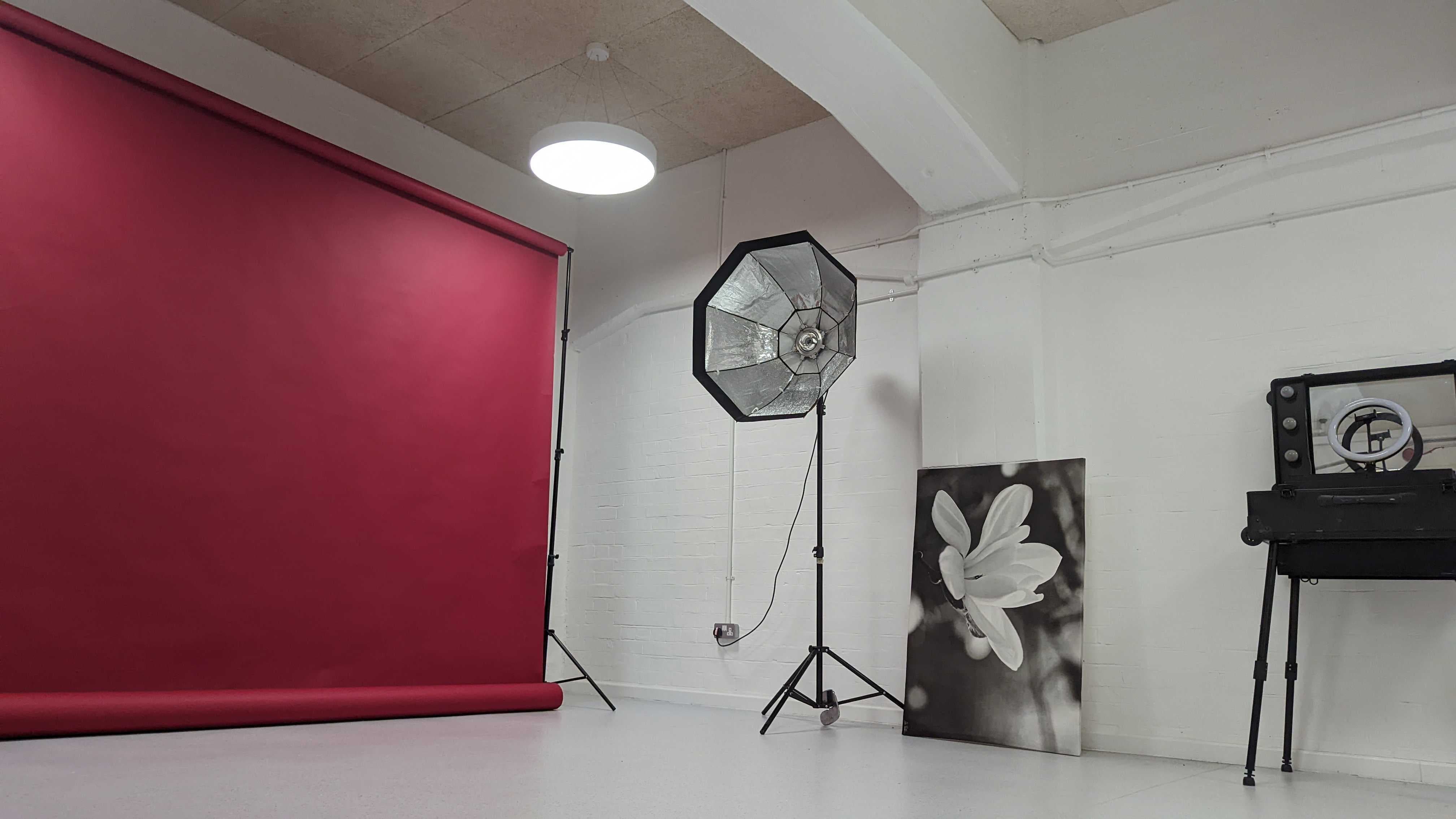 Vision Wharf Studios event space with red backdrop, ideal for workshops and gatherings.