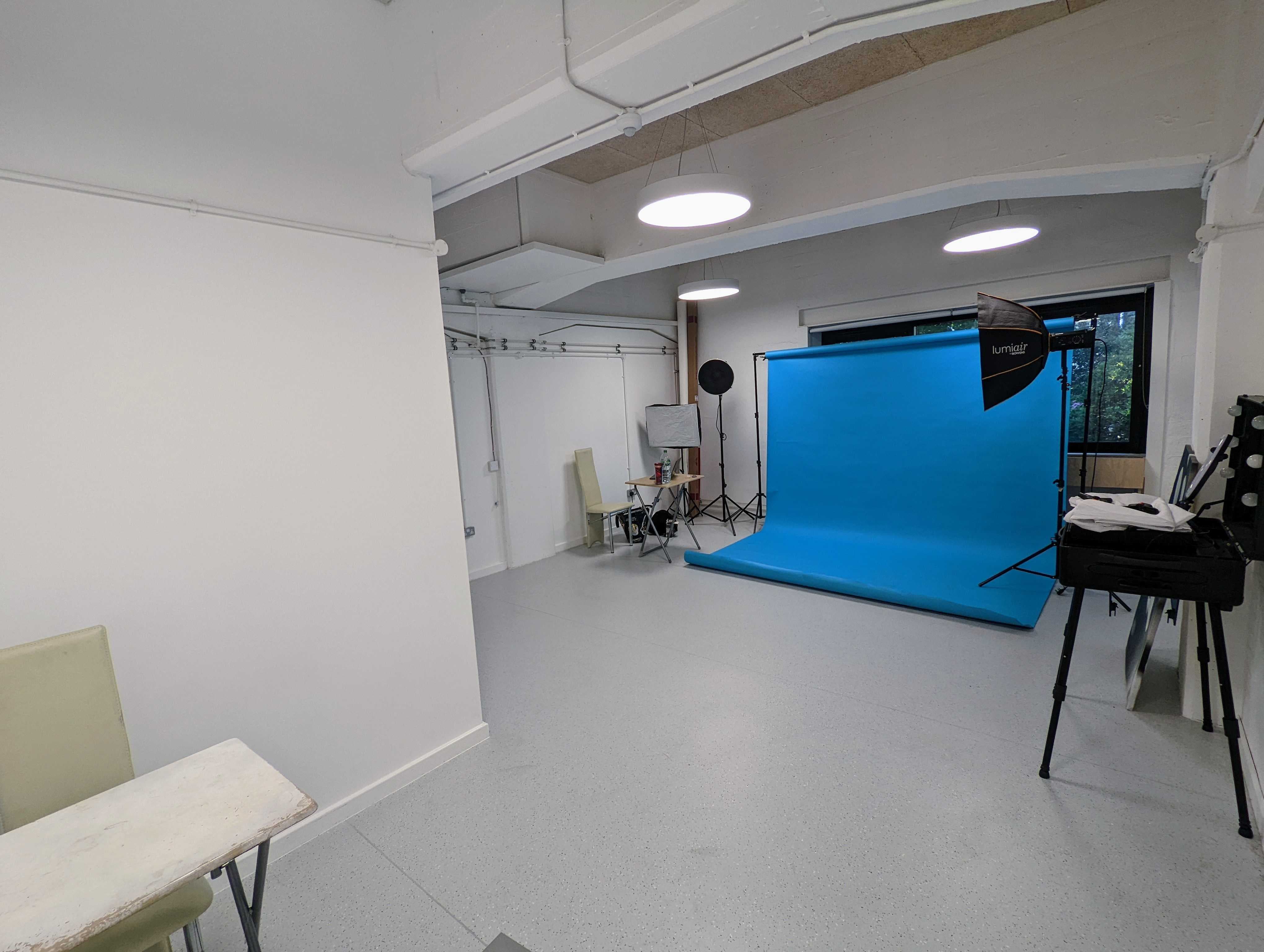 Vision Wharf Studios event space with bright blue backdrop for workshops and photo shoots.