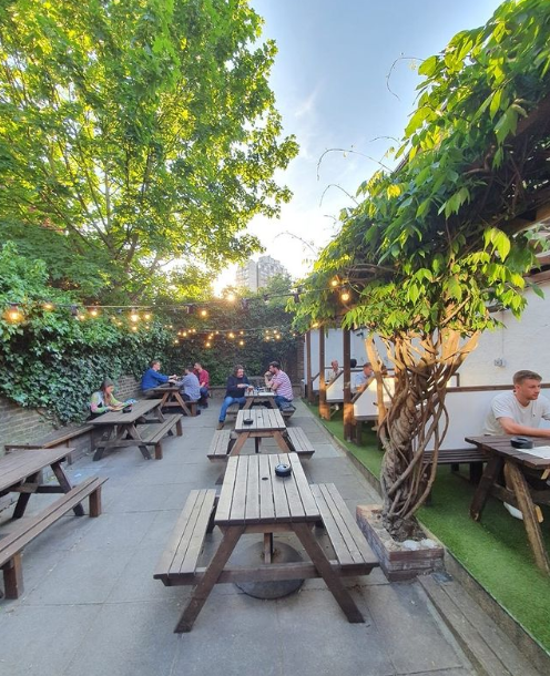 Charming outdoor venue with string lights for casual meetings and networking events.