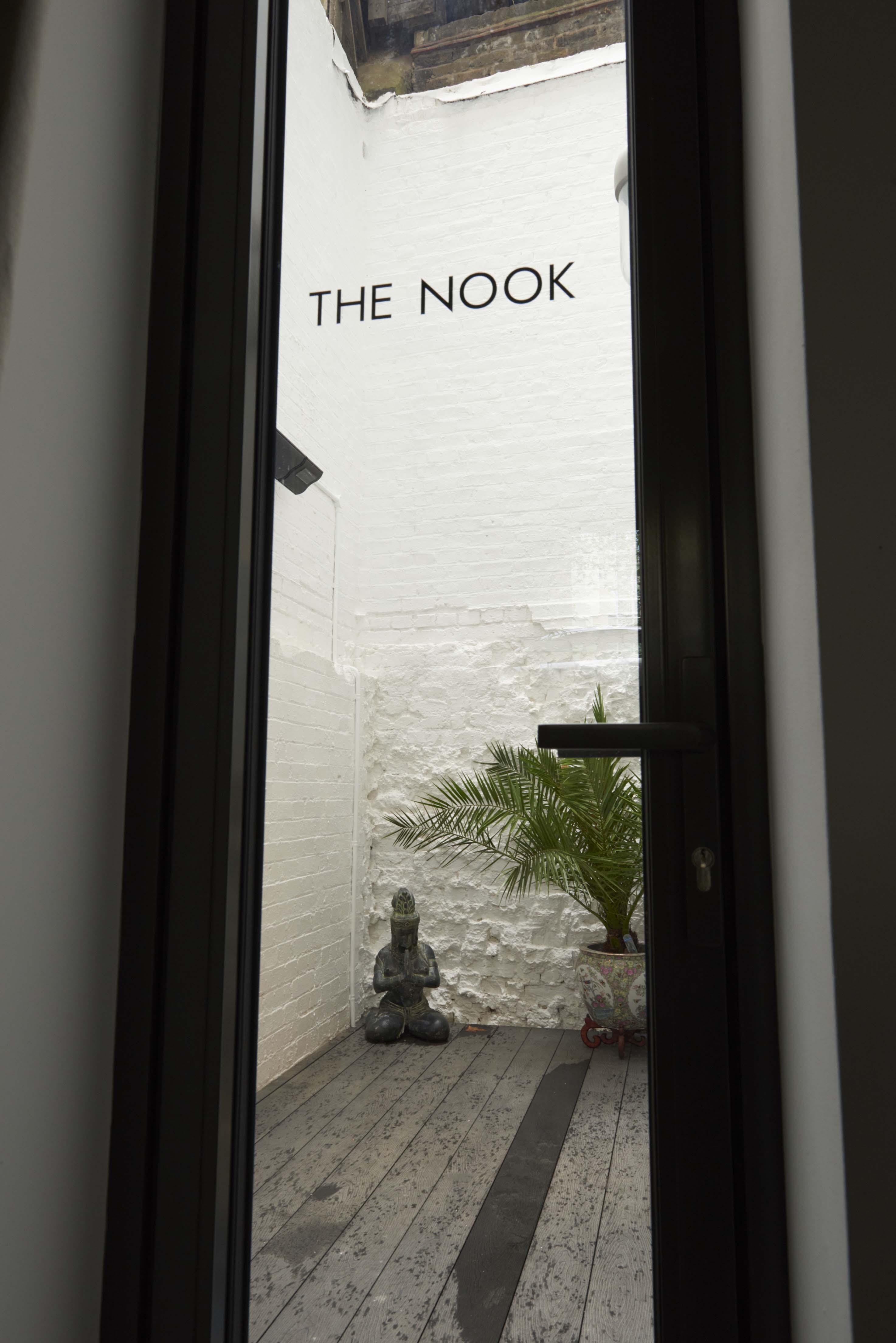 Agdon House serene meeting space with white walls and greenery for events and gatherings.