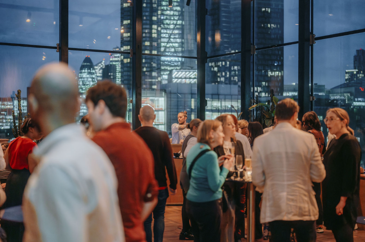 Vibrant networking event at One Hundred Shoreditch Hotel with city views and stylish decor.
