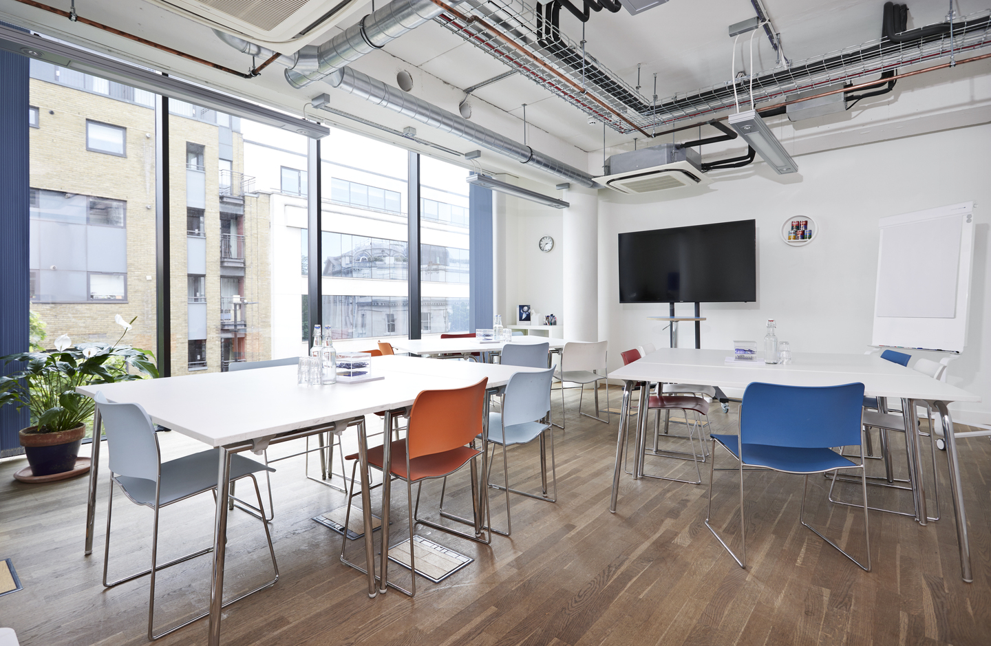 Modern meeting space at Wallacespace Clerkenwell with colorful chairs for workshops.