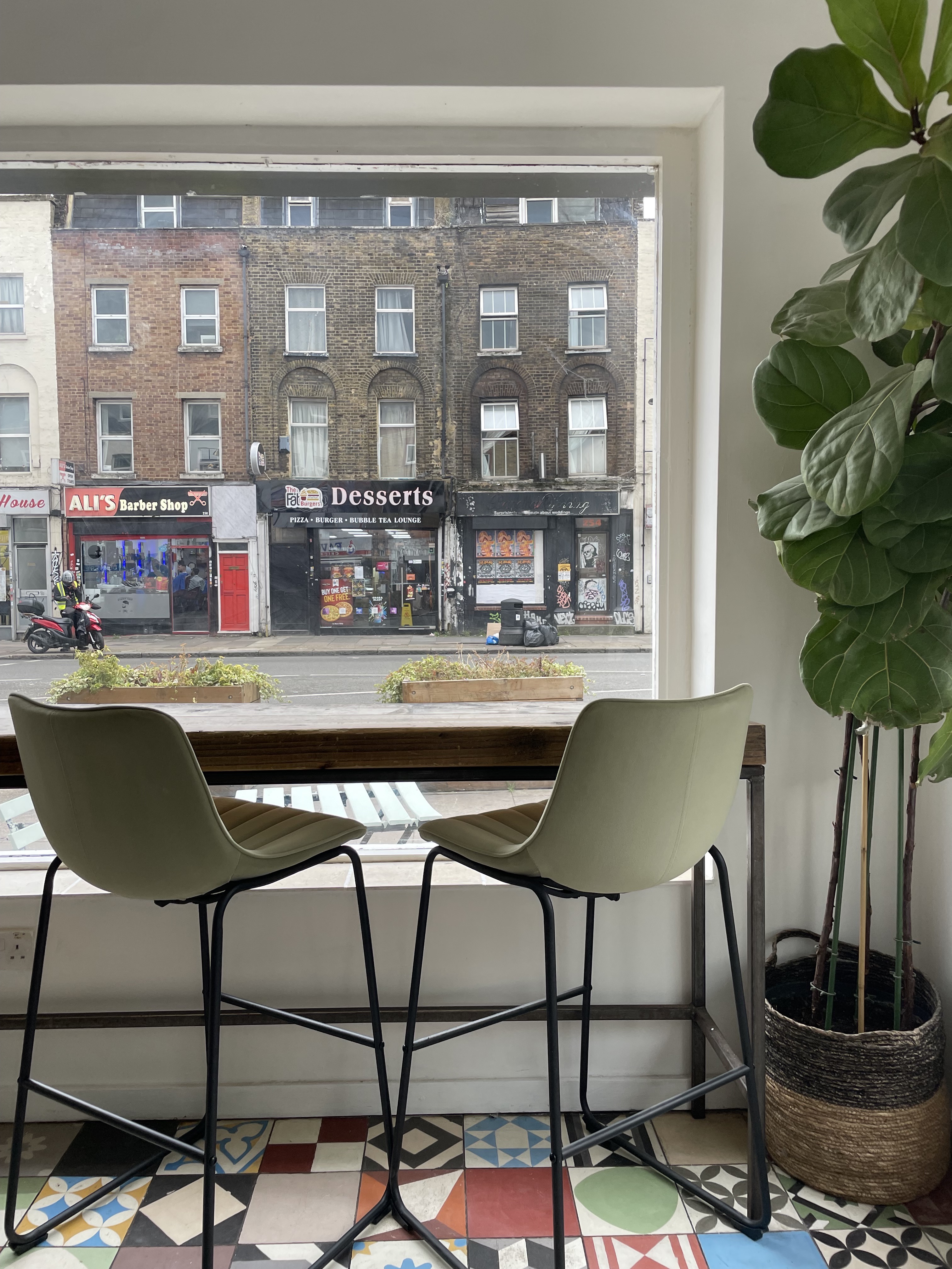 Cozy café with natural light, minimalist seating for casual meetings and networking.