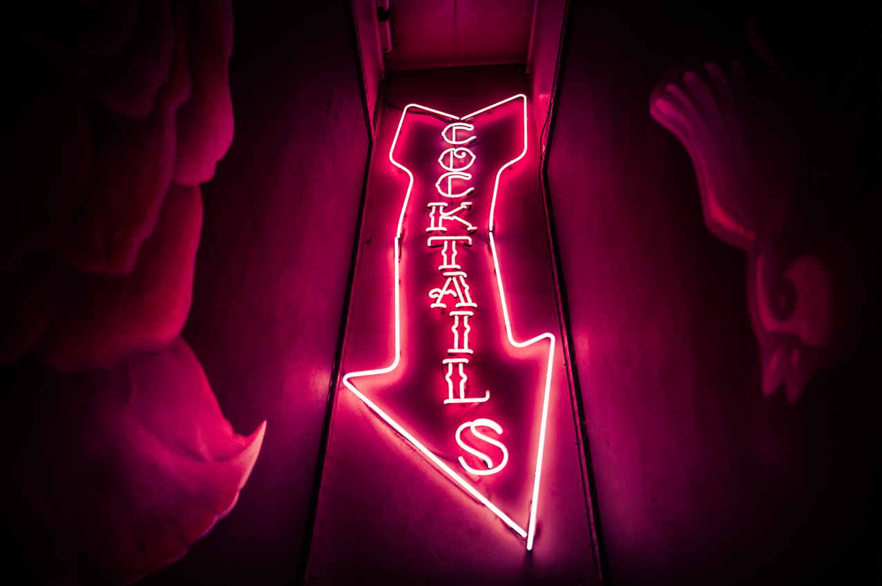Vibrant neon cocktail sign at The Cocktail Club Cardiff for social events and networking.