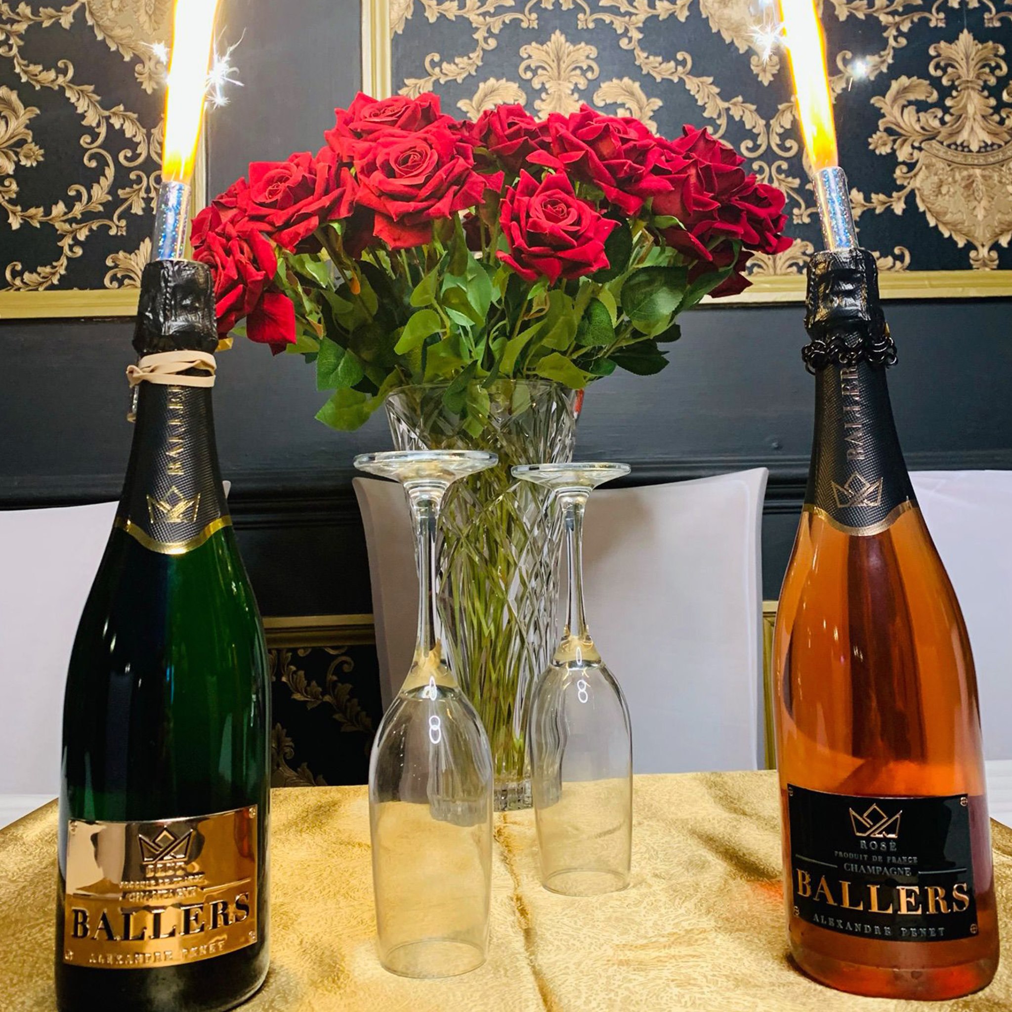 Elegant ballroom table setting with champagne and roses for weddings or anniversaries.