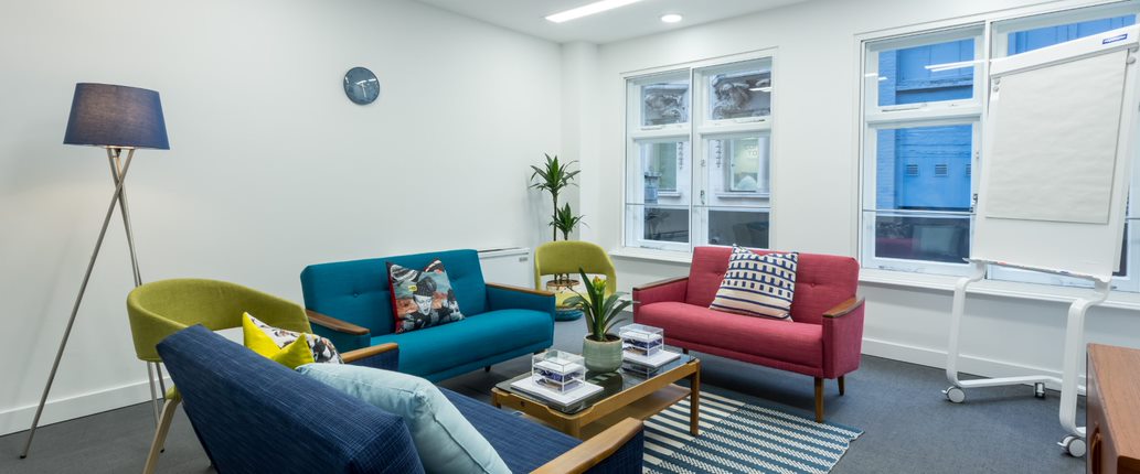 Modern meeting space with vibrant furniture for creative brainstorming in Covent Garden.