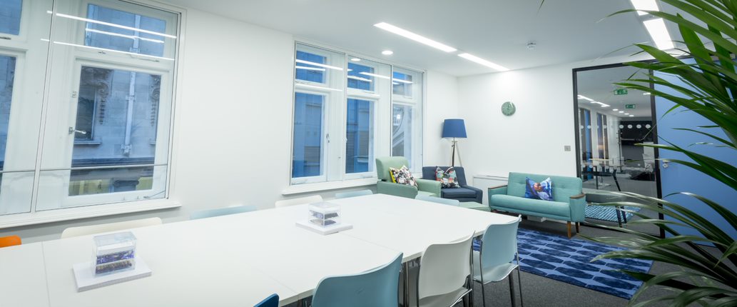 Modern meeting space in Covent Garden with colorful chairs for collaborative events.