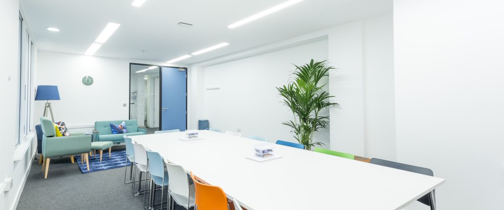 Modern meeting room in Covent Garden with colorful chairs for workshops and brainstorming.