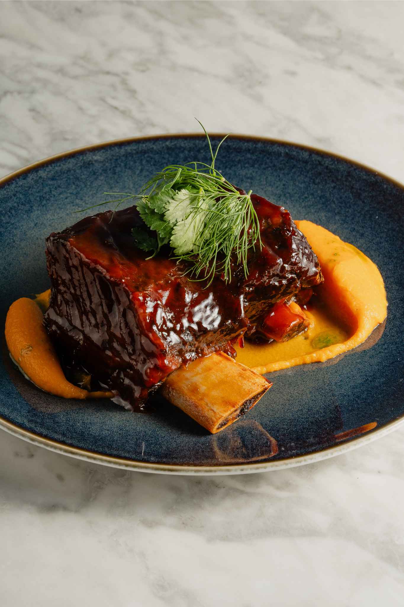 "Mezemiso Rooftop Restaurant dish with glazed meat, perfect for upscale events and dinners."