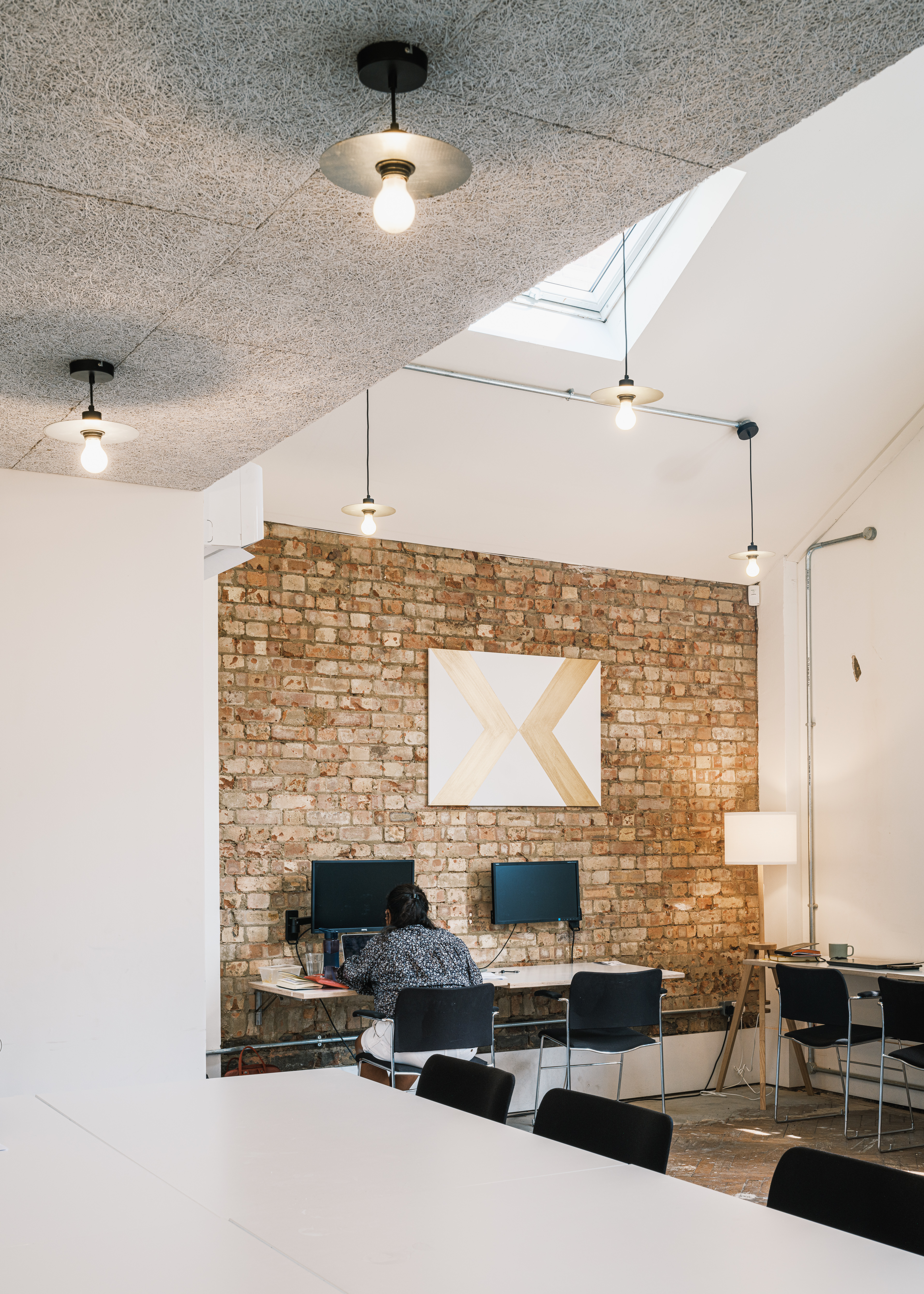Modern meeting room with exposed brick wall, ideal for events and private dining.