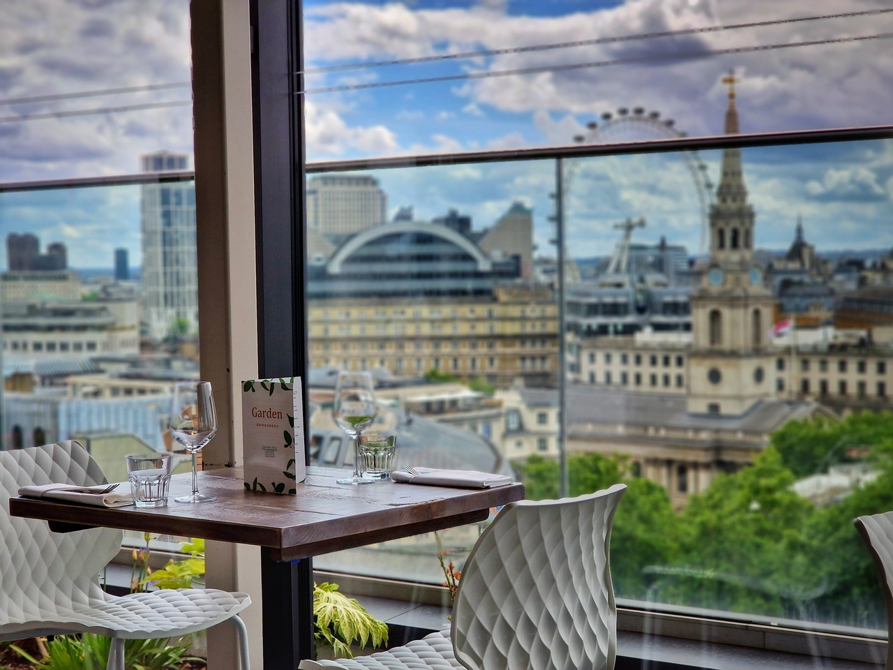 Elegant rooftop dining venue with London skyline view, perfect for corporate events.