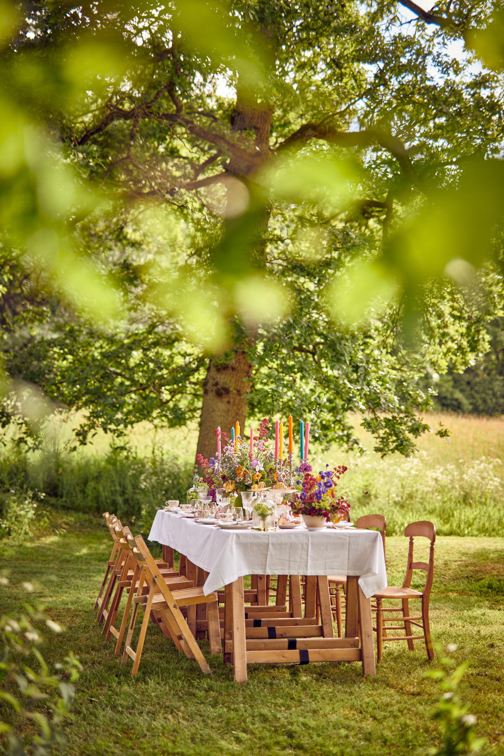 Elegant outdoor dining table with floral arrangements for weddings and garden parties.