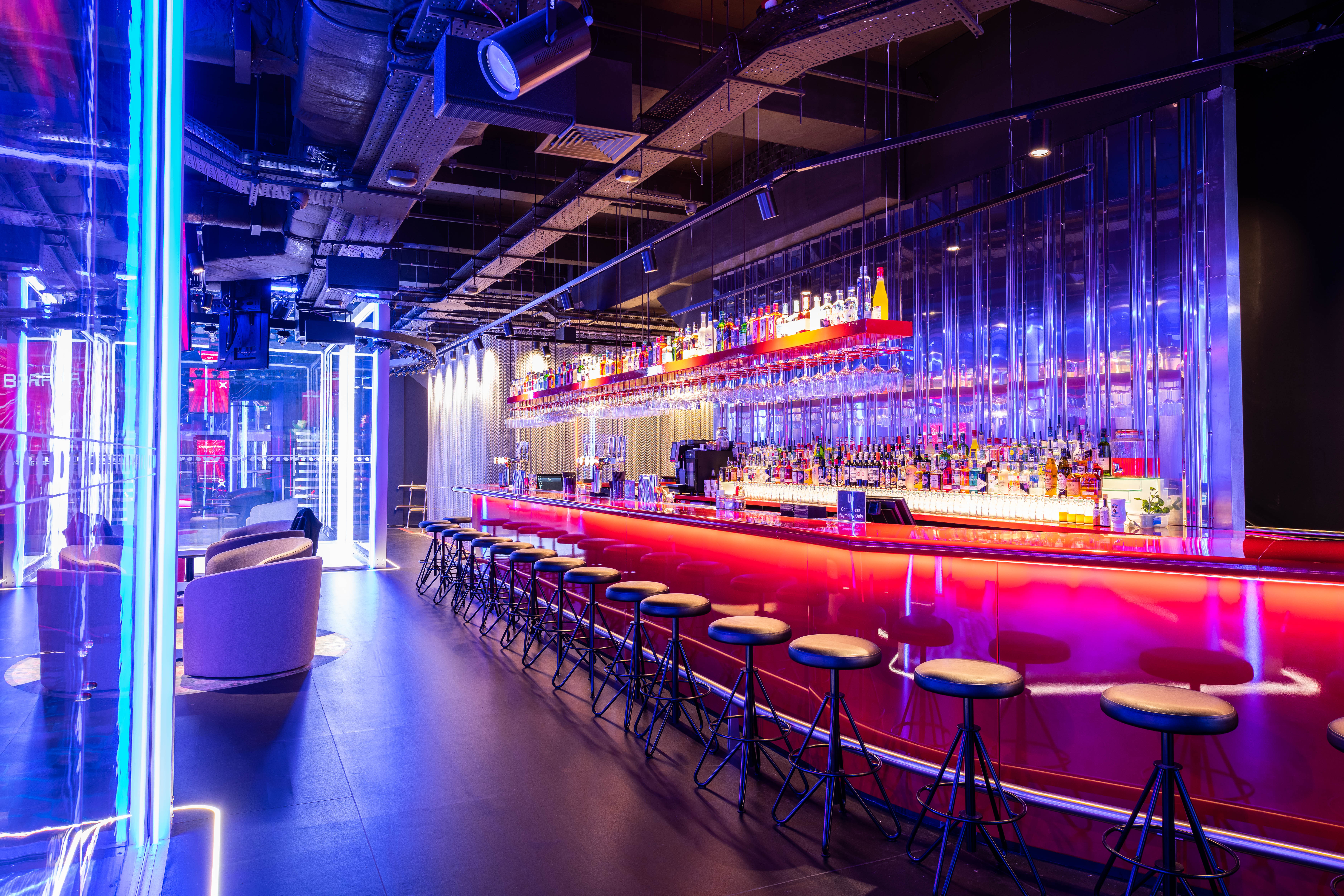 Modern bar space with colorful lighting for events and gatherings in Urban Playground.