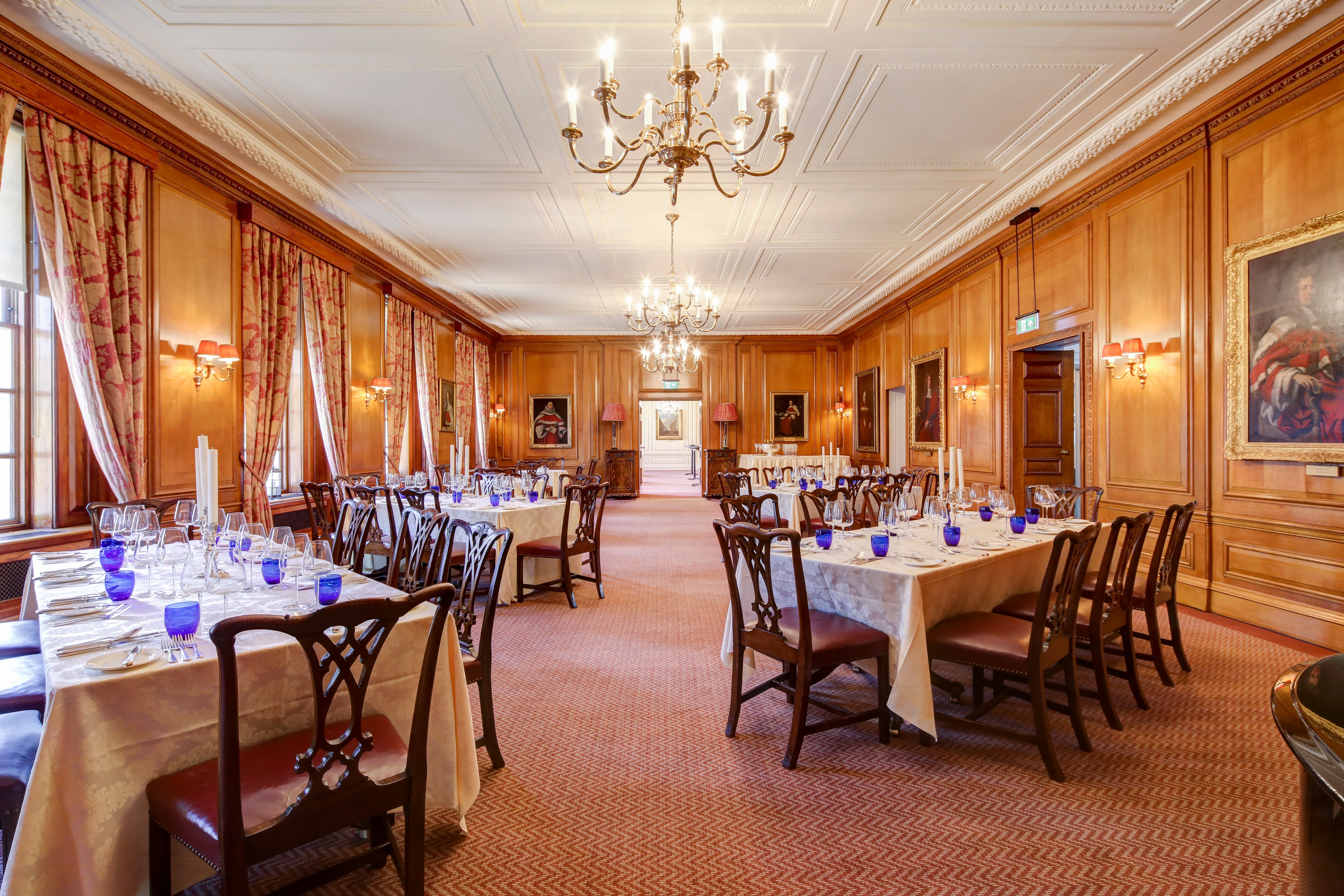 Elegant wood-paneled Parliament Chamber for formal banquet and corporate networking dinner.