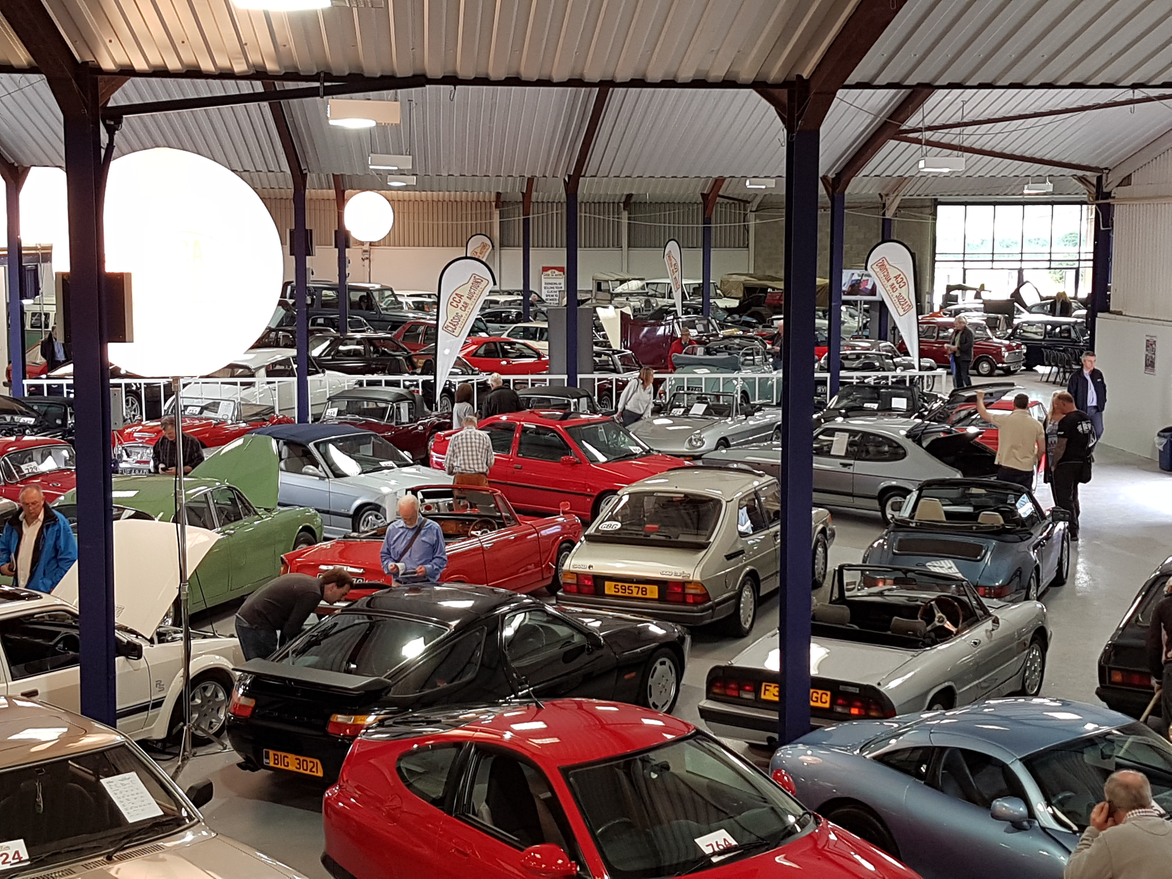 Vibrant automotive exhibition at Warwickshire Event Centre with classic and modern cars.