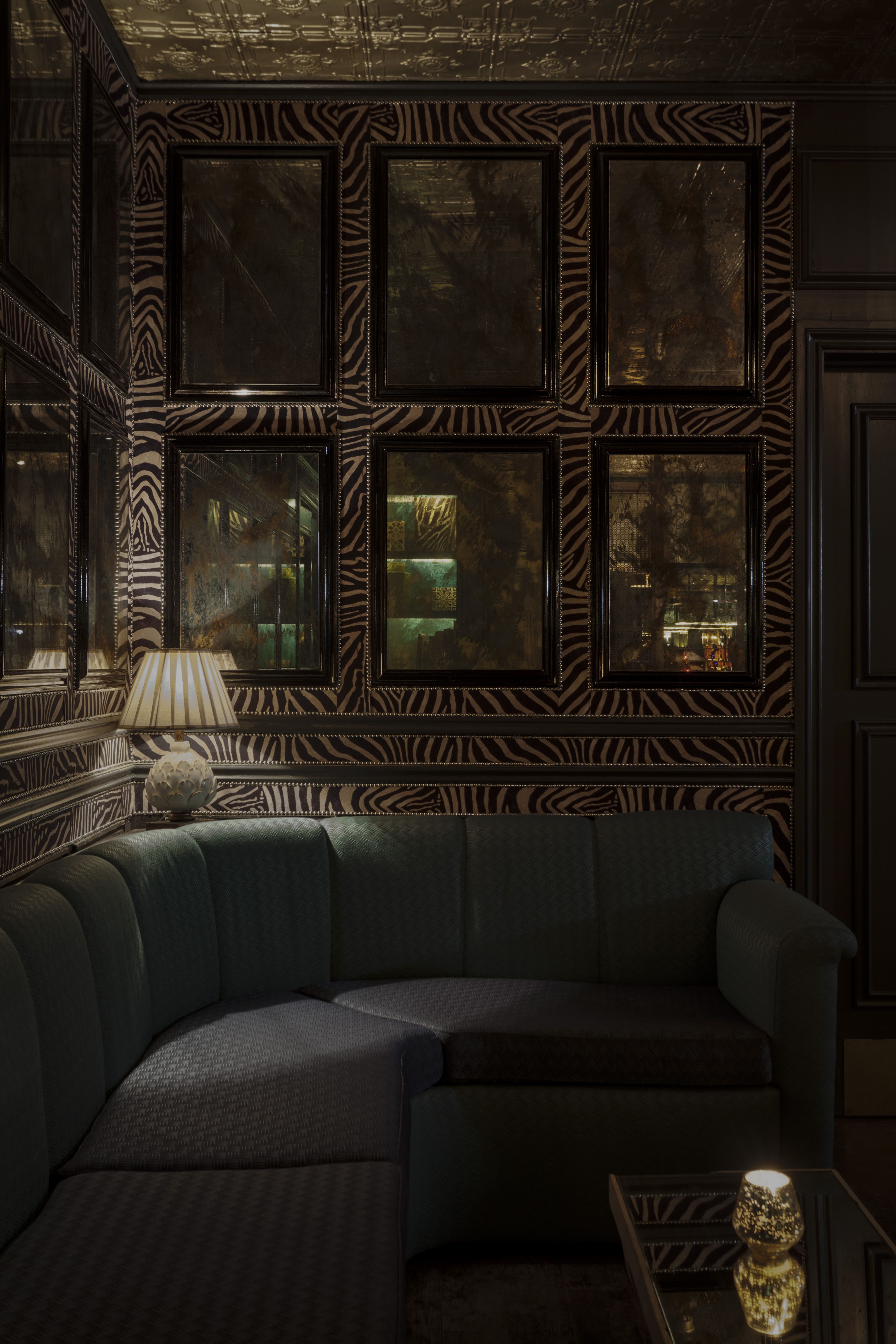 Stylish lounge bar with zebra-striped wallpaper, perfect for networking events.