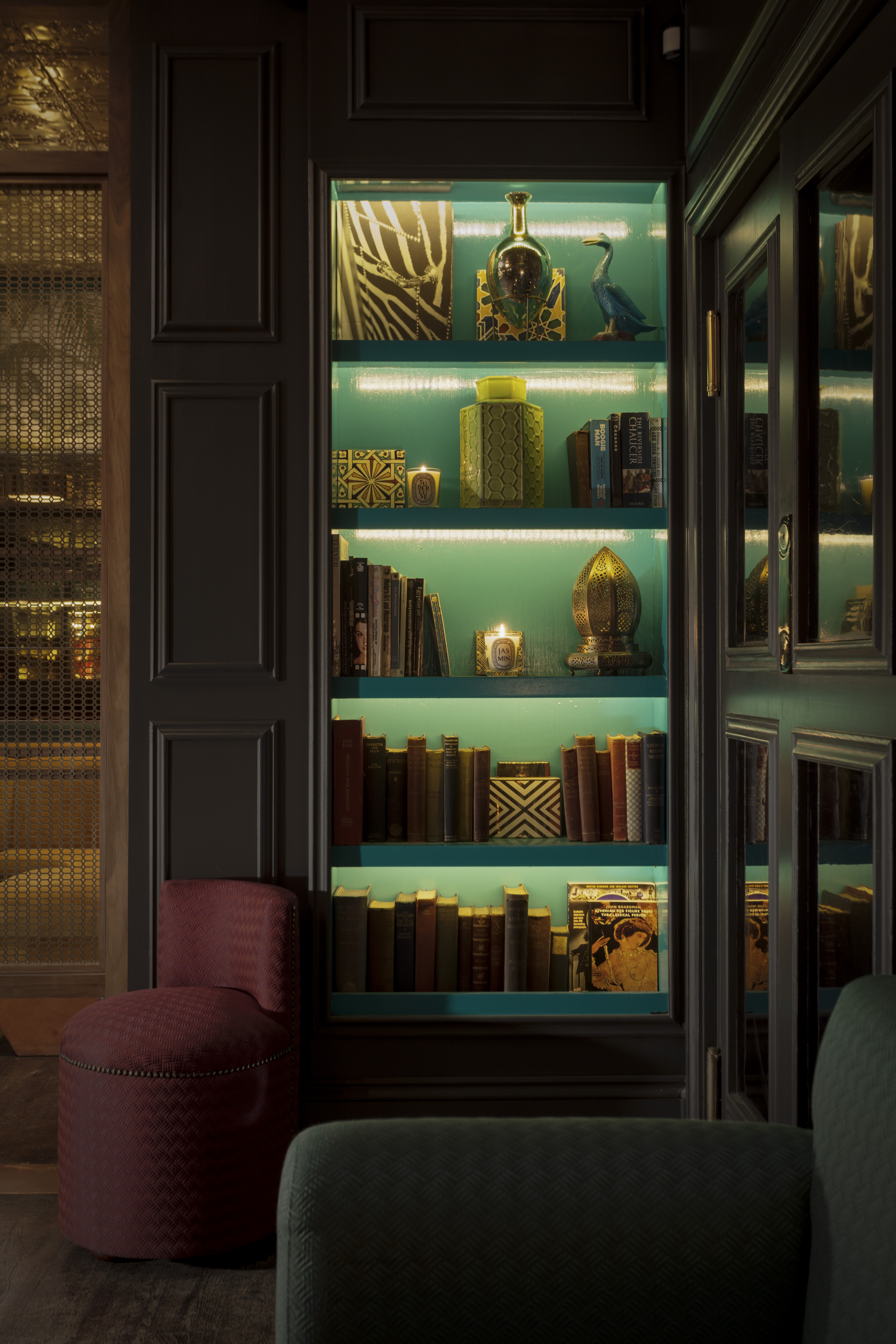 Lounge Bar bookshelf with teal backdrop, perfect for networking events and gatherings.
