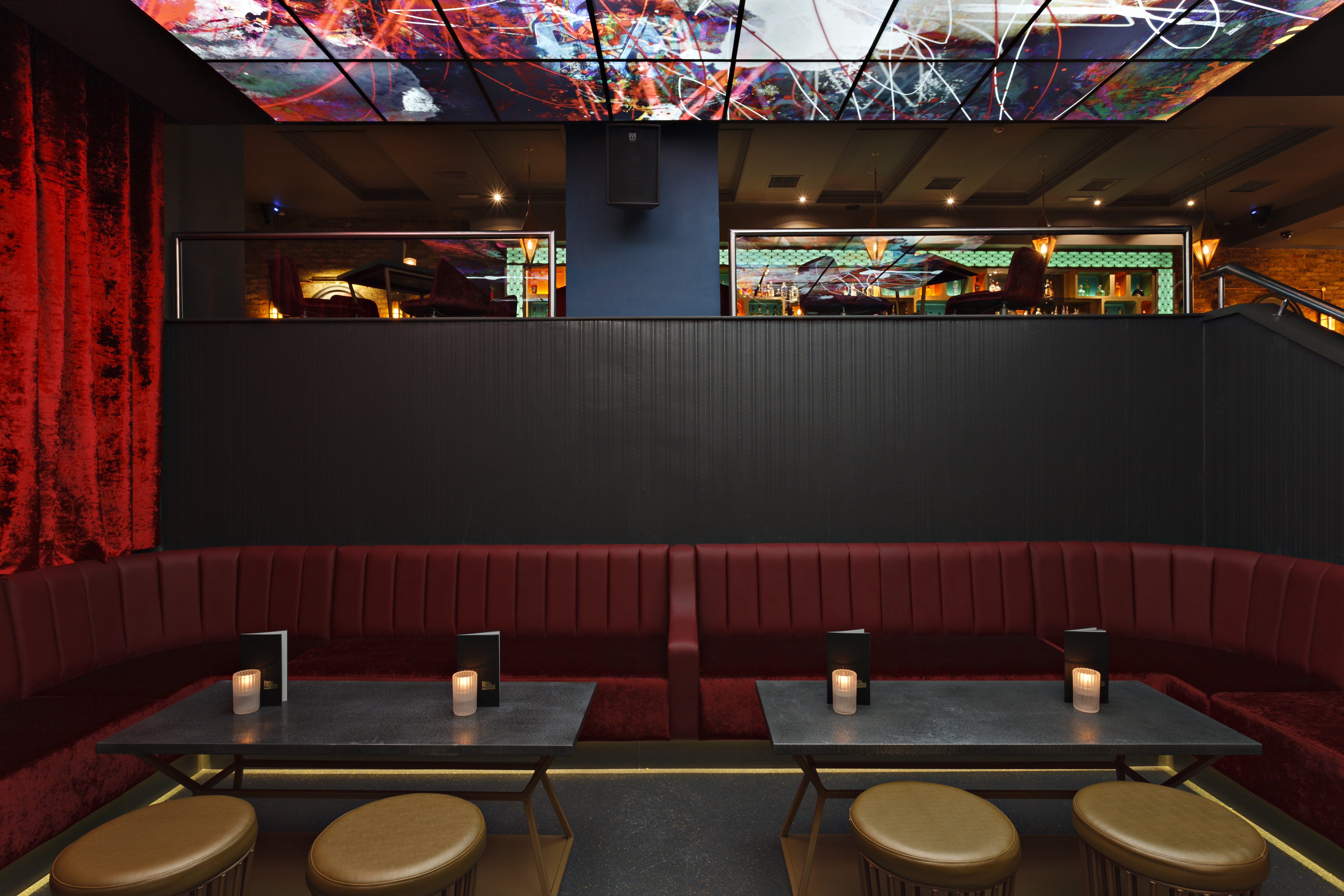 Stylish Martini Den with plush red seating, ideal for upscale events and networking.