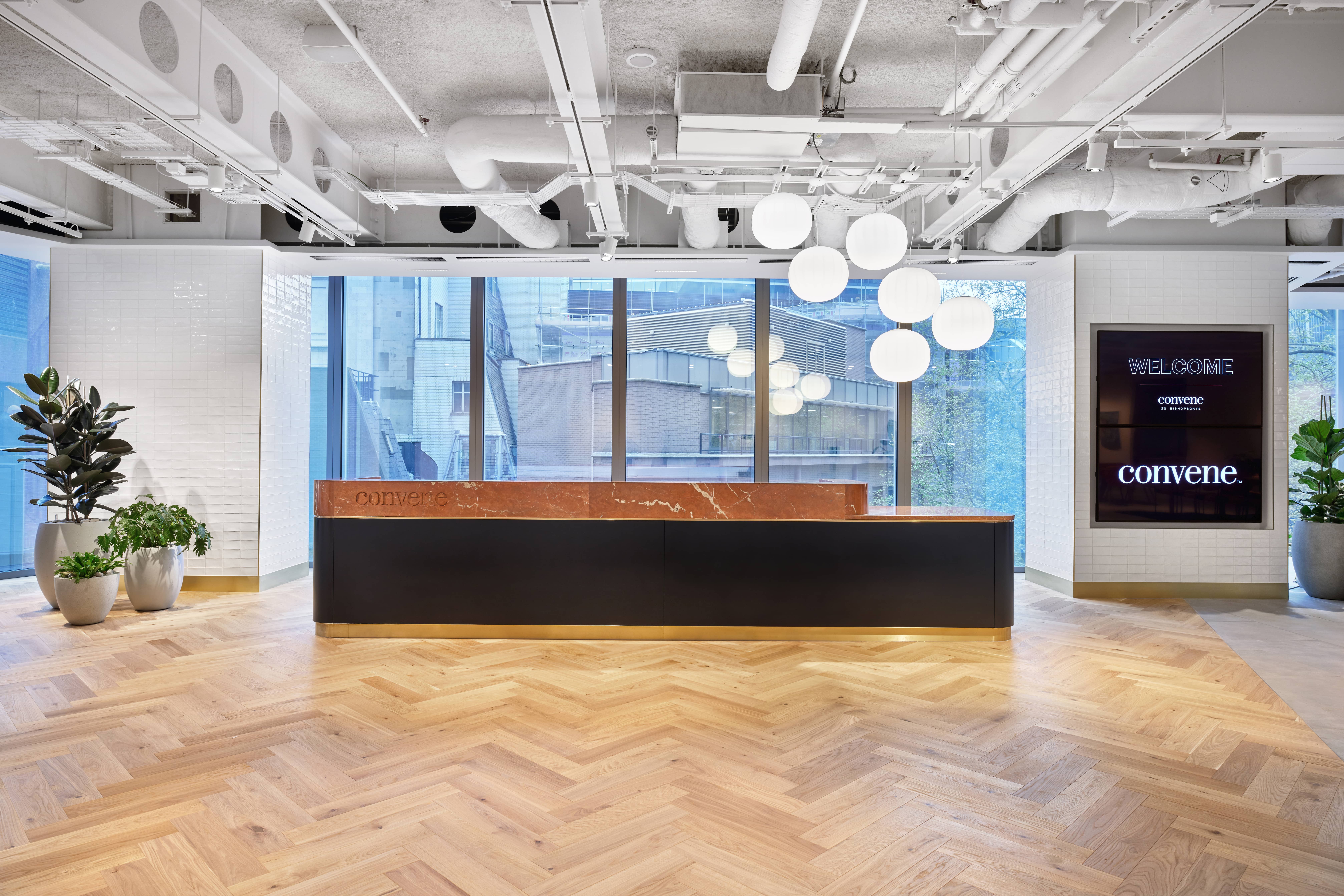 Modern reception area with sleek desk and natural light for events at Convene 22 Bishopsgate.