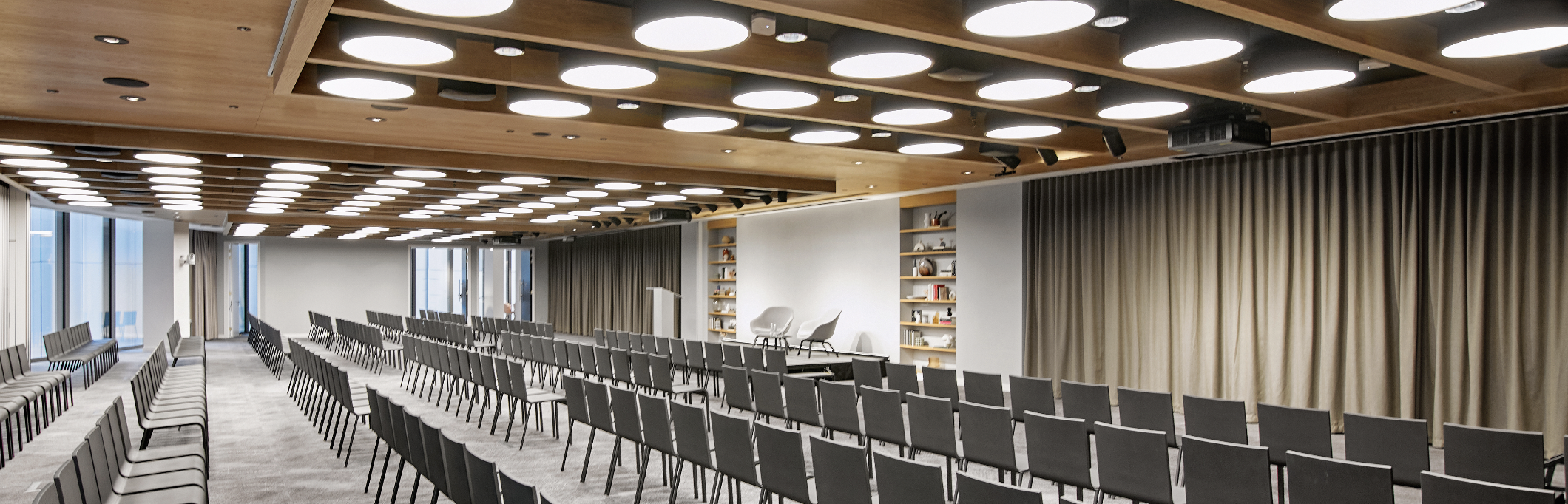 Modern event space with minimalist stage for corporate meetings and conferences.