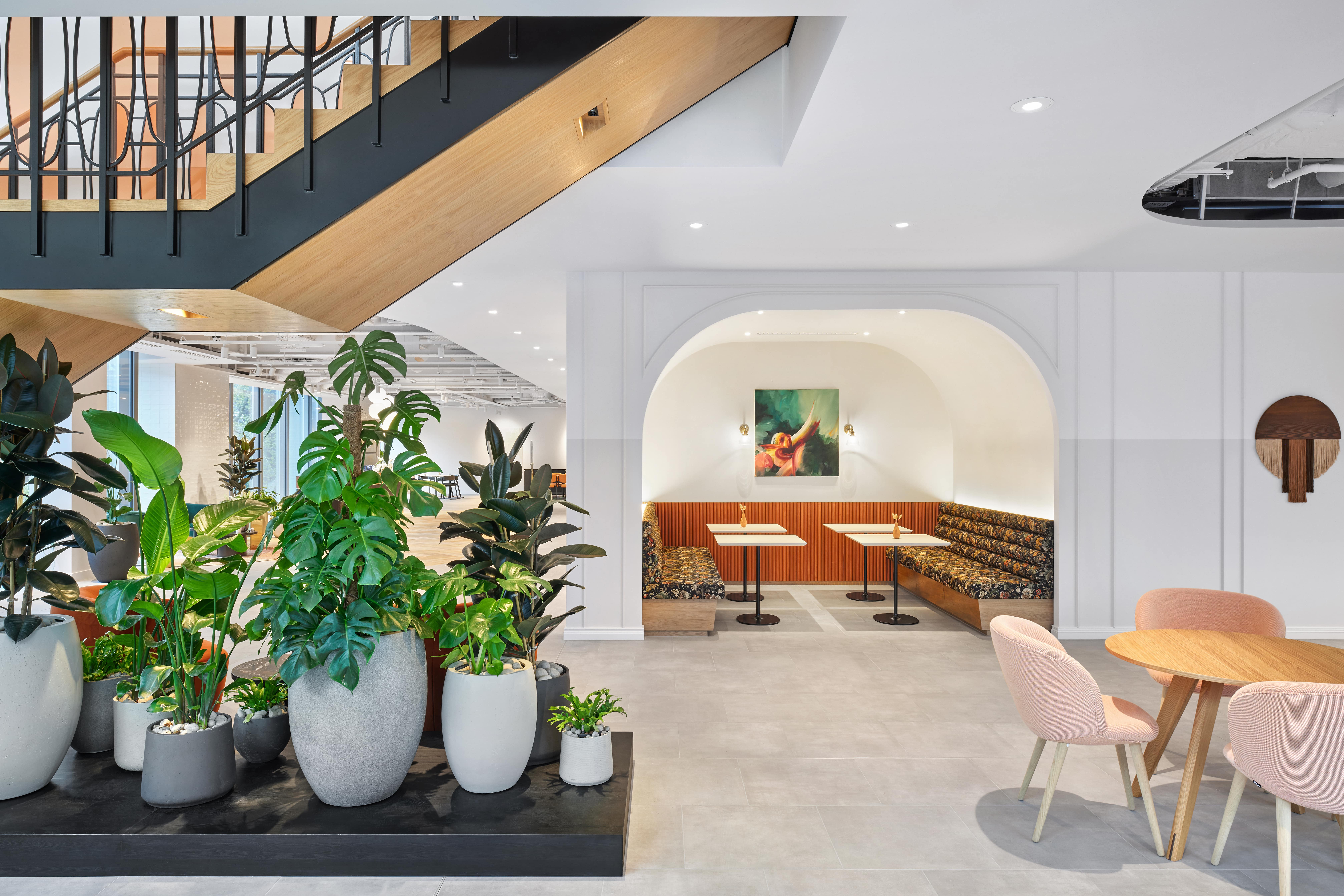 Modern event space with greenery and stylish staircase for networking at Convene 22 Bishopsgate.