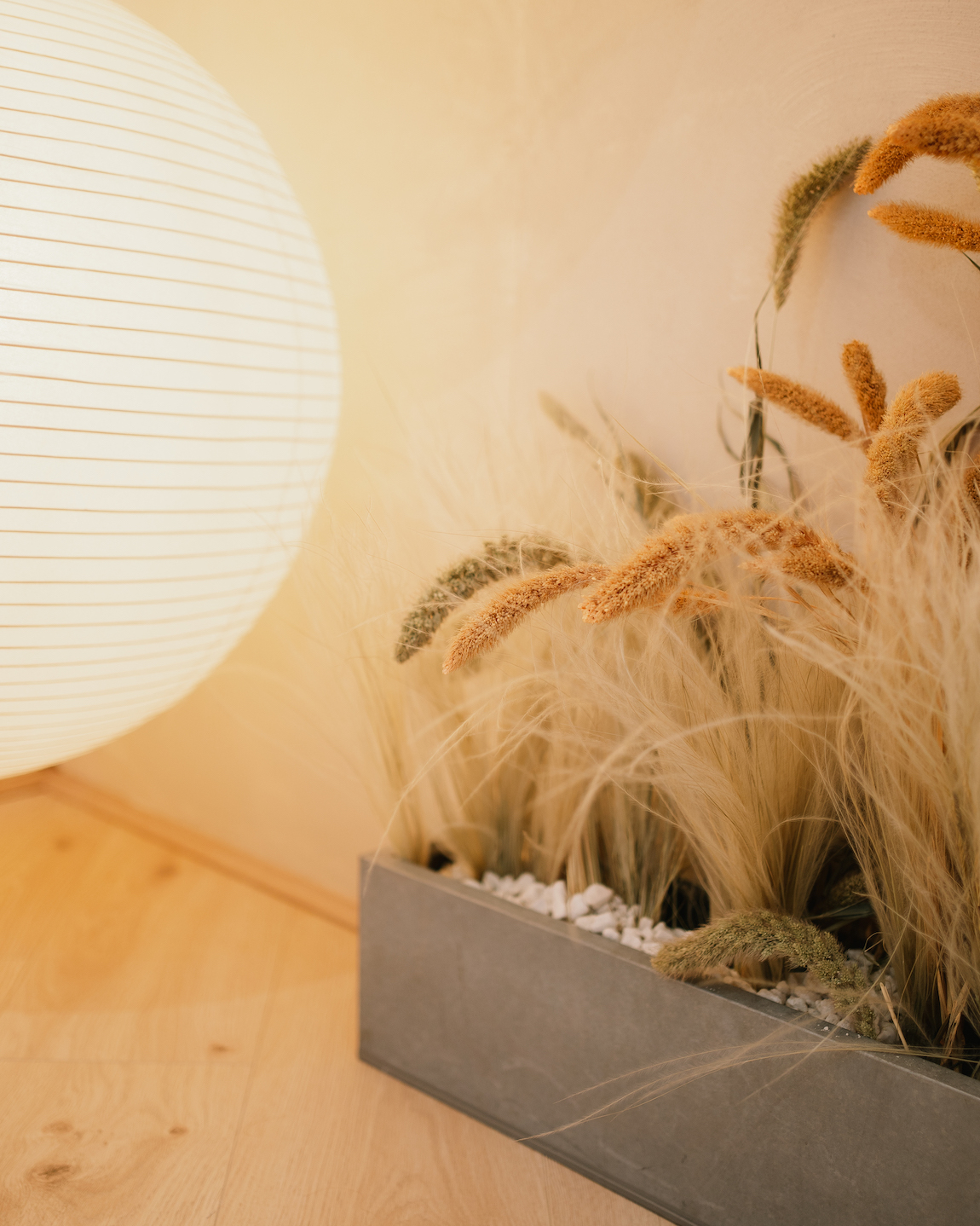Elegant event setting with lanterns and dried grasses for intimate gatherings.