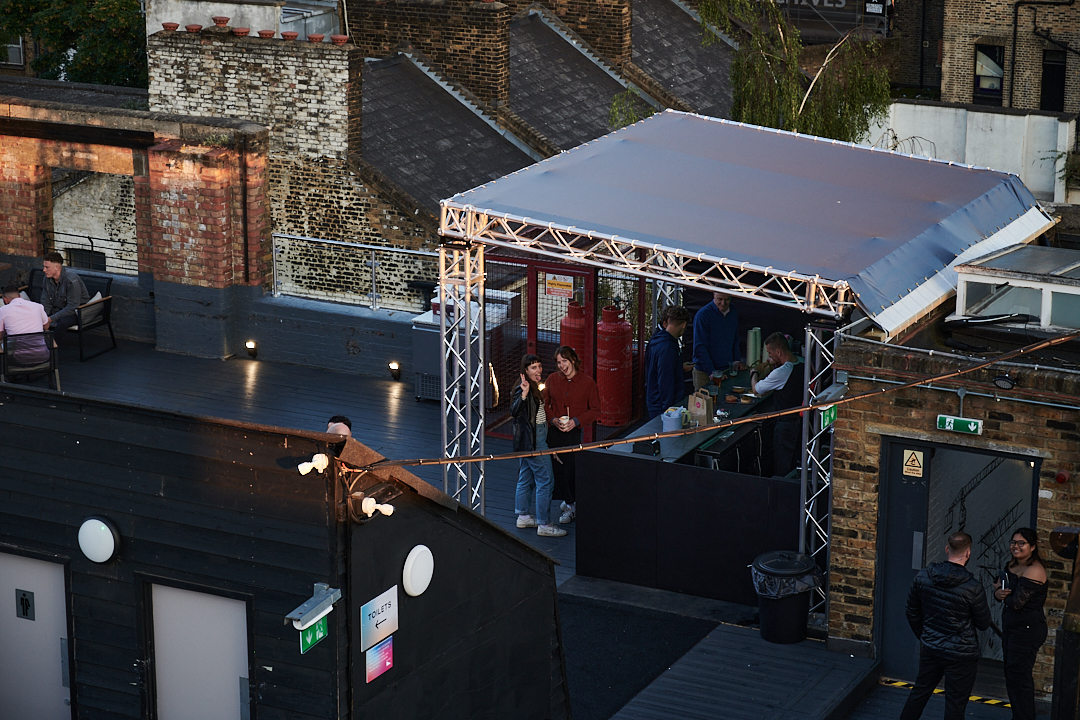 Dalston Roofpark rooftop event space with canopy, ideal for casual gatherings and networking.