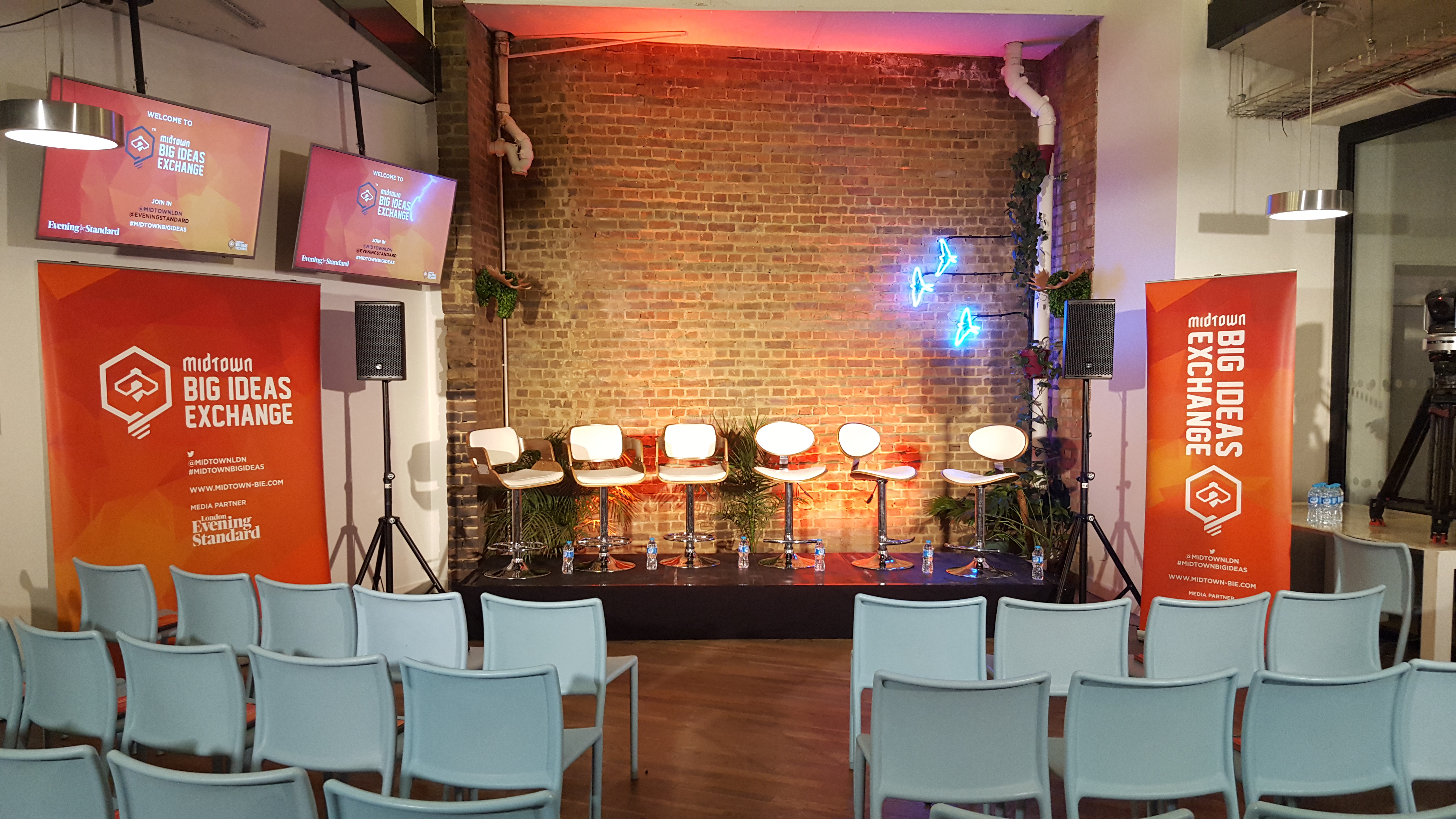 Clerkenwell Kitchen event space with modern stage setup for panel discussions and networking.
