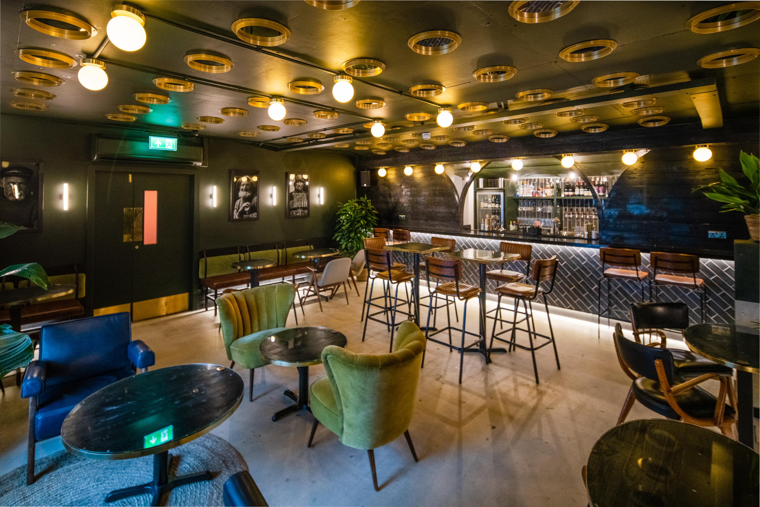 Stylish event space with chic bar and ambient lighting for networking or private parties.