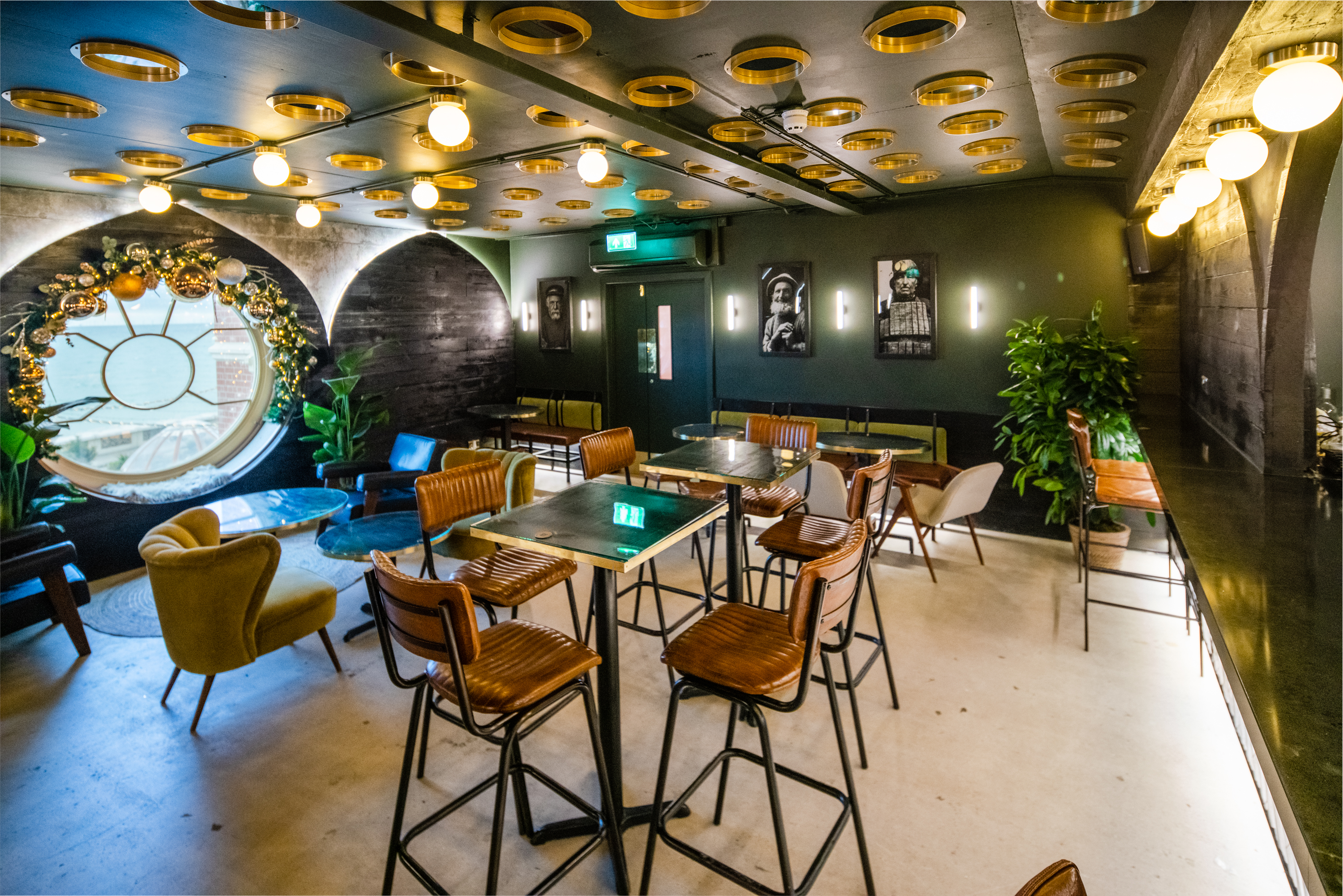 Stylish event space with circular window, ideal for networking and workshops.