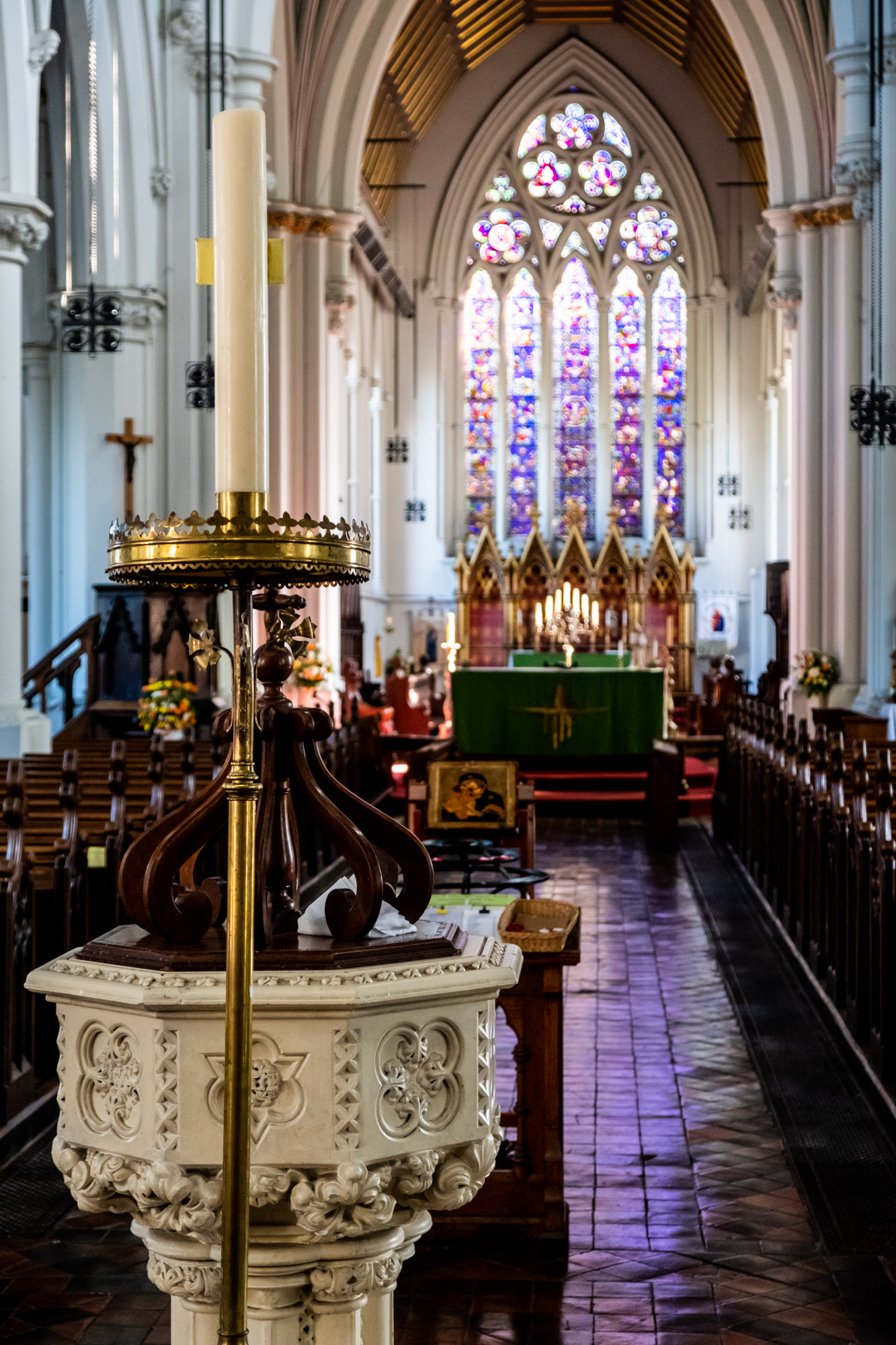 St Giles Church interior with vibrant stained glass, perfect for weddings and gatherings.