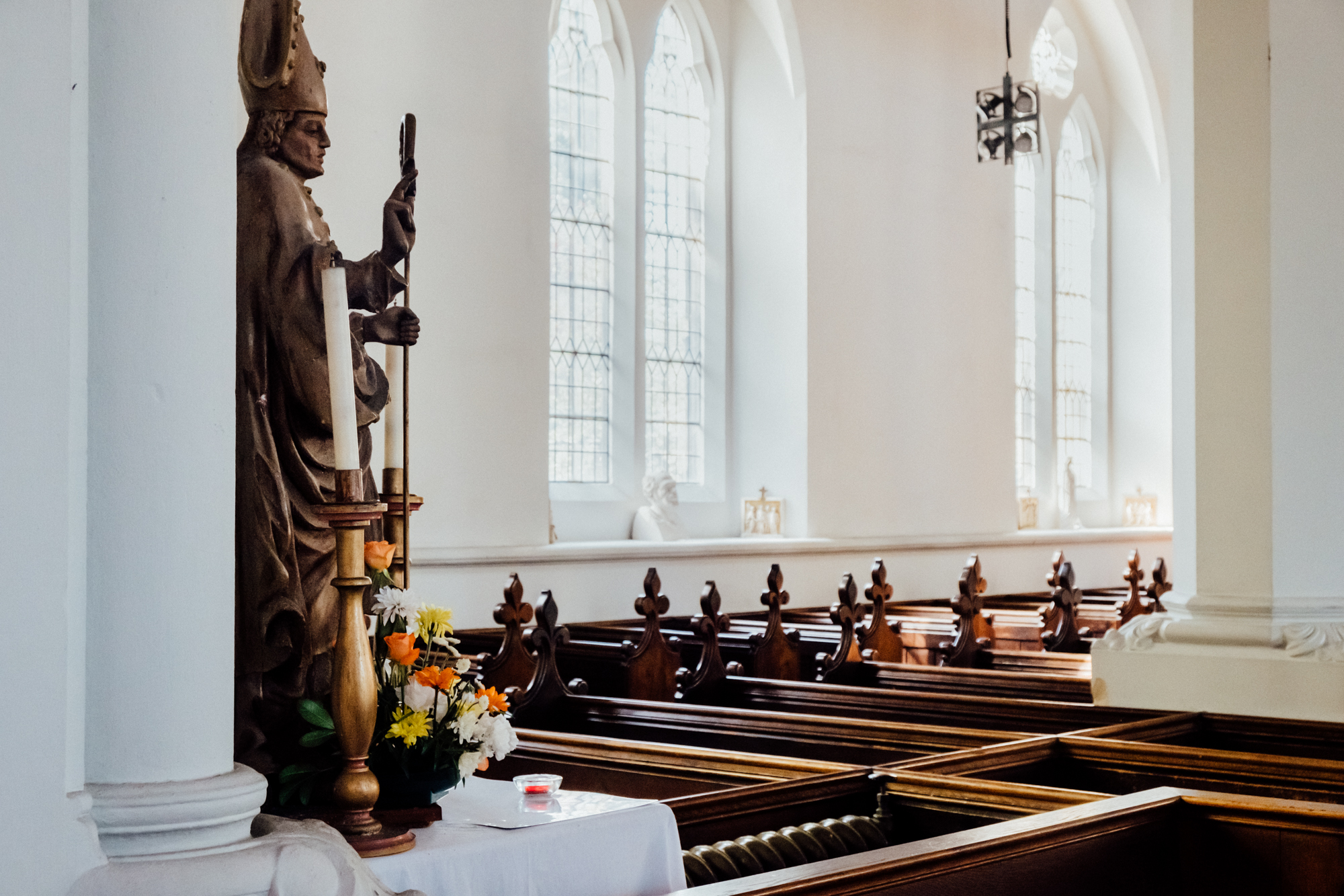 St Giles Church interior with stained glass, perfect for weddings and memorials.