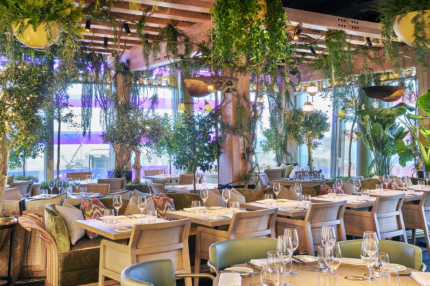 Elegant dining space at 14 Hills, perfect for upscale events with lush greenery.