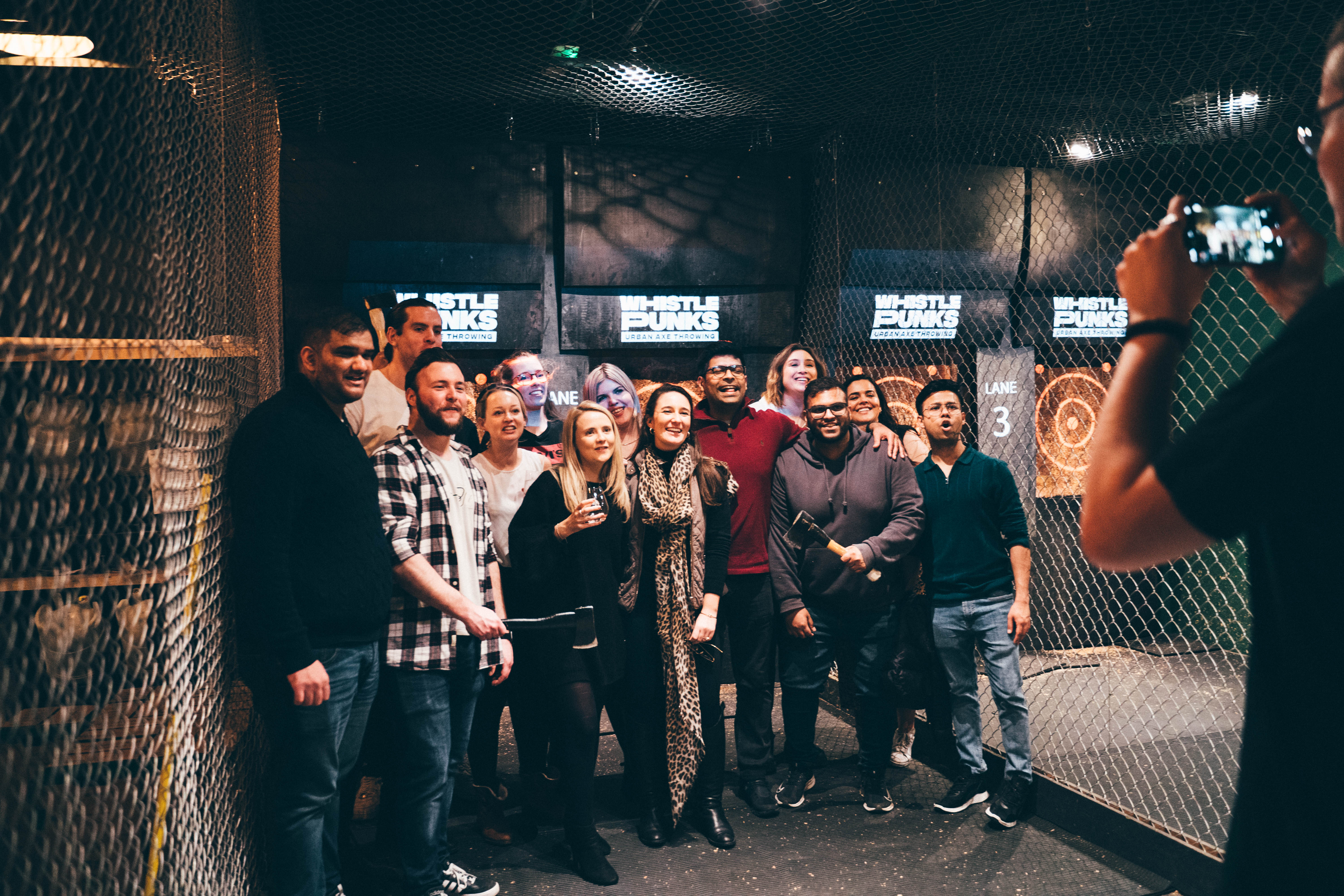 "Group photo at Whistle Punks Urban Axe Throwing, ideal for team-building events."