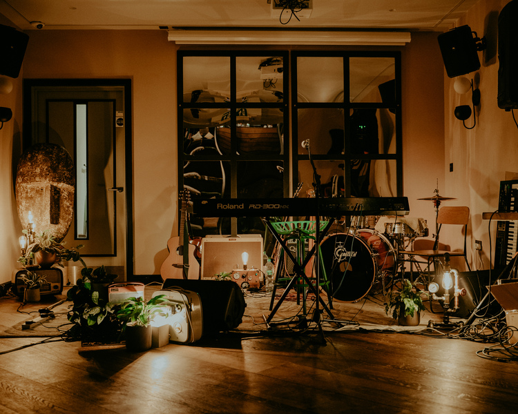 Intimate live music stage setup at Power Plant, Selina UK with warm ambient lighting.