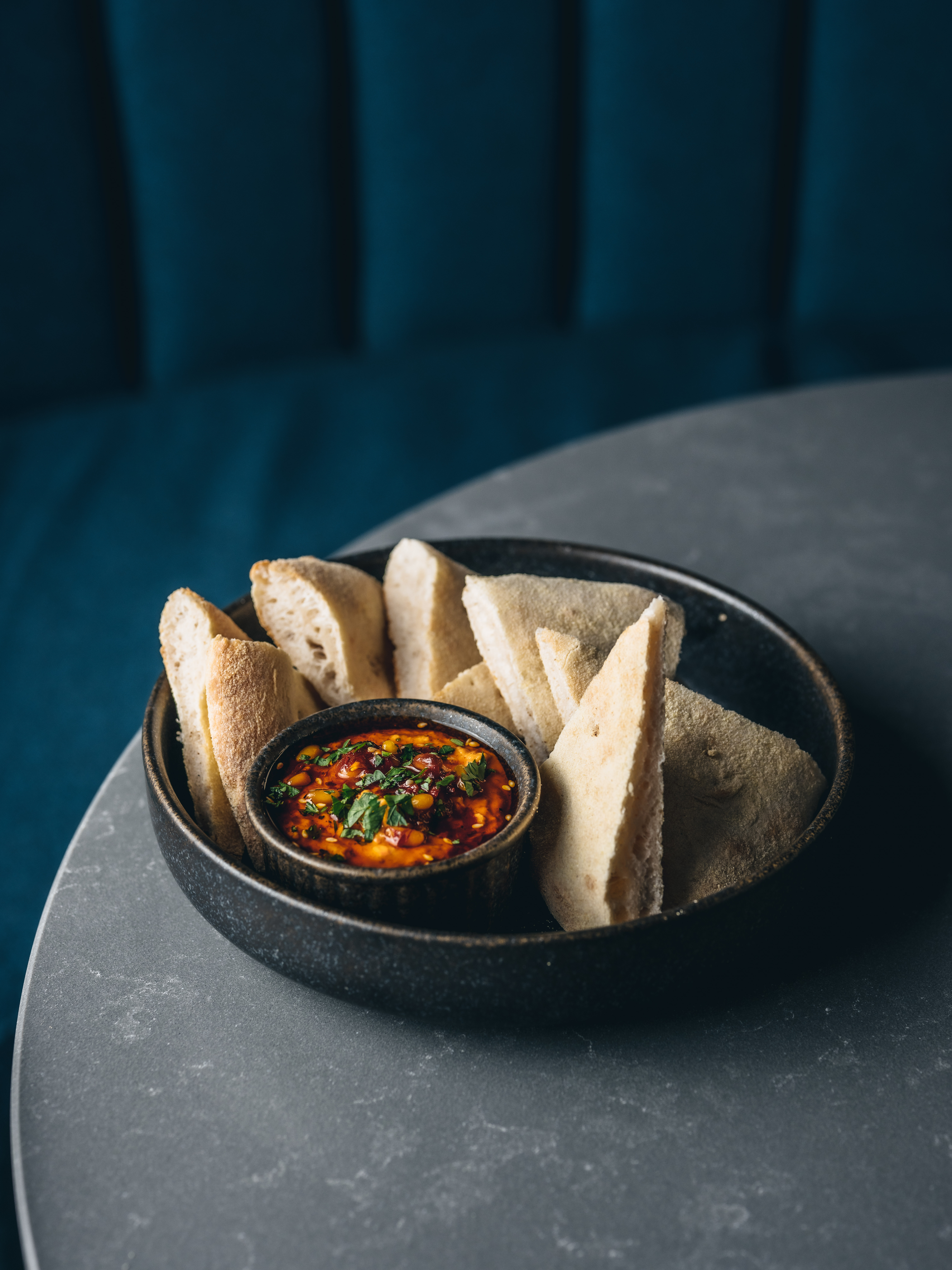 "Elegant dish with soft bread and spicy dip at Exclusive Venue Hire, Oche The Strand."