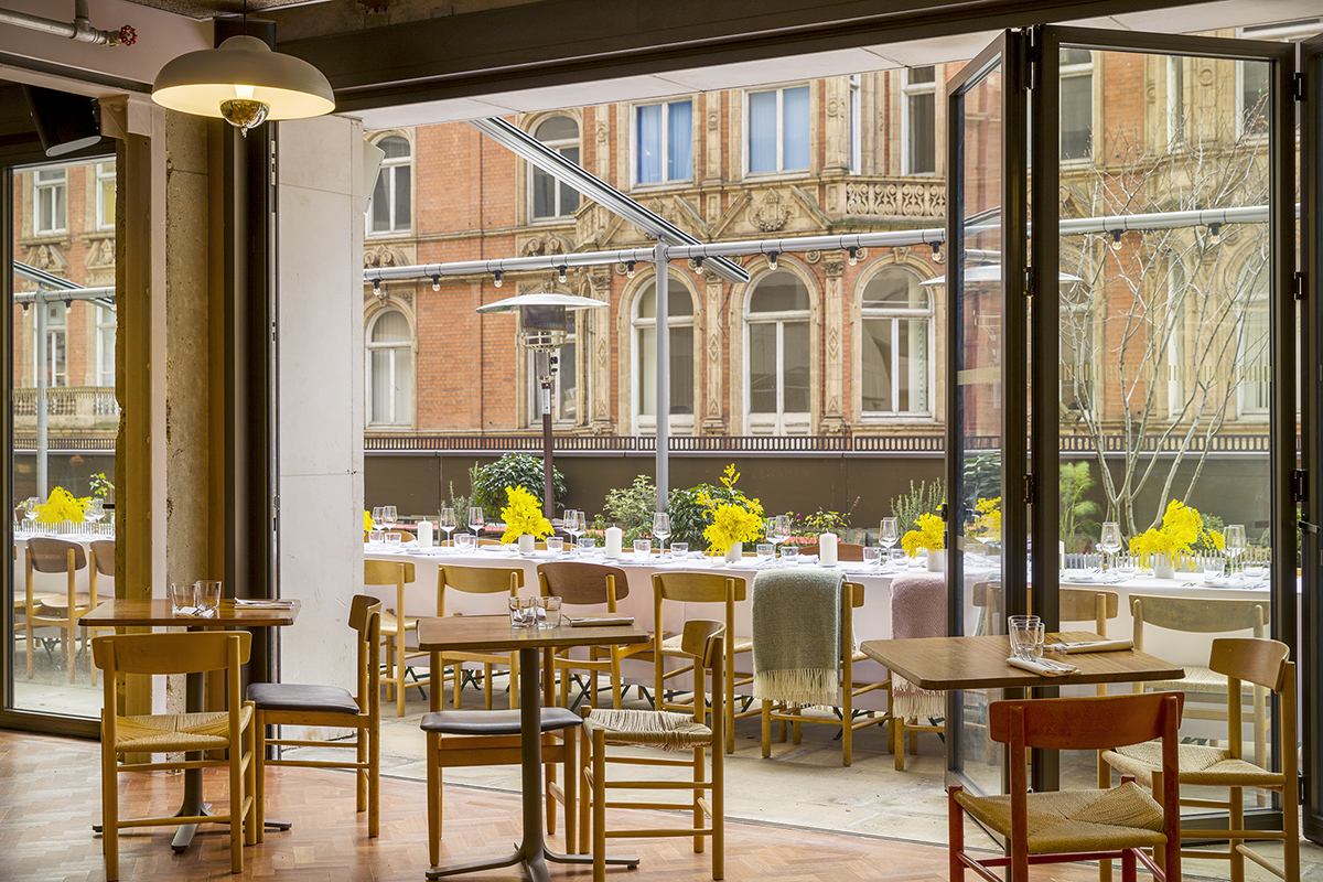 Stylish event space at Toklas Restaurant with large windows, perfect for gatherings and celebrations.